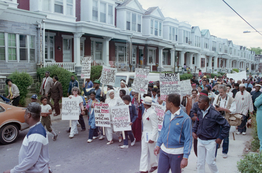 MOVE Protesters Holding Placards