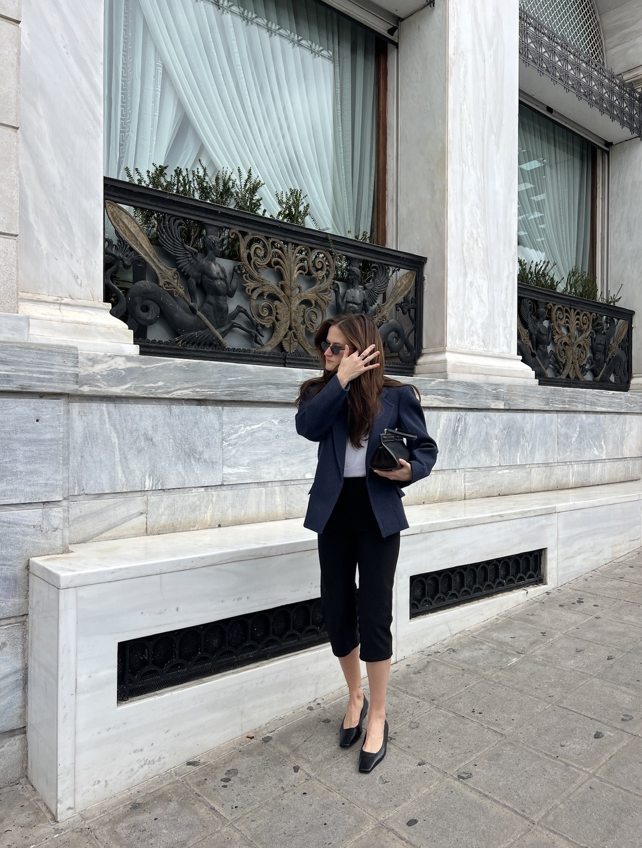Eliza Huber wearing a COS navy blazer with COS capri pants and shoes.