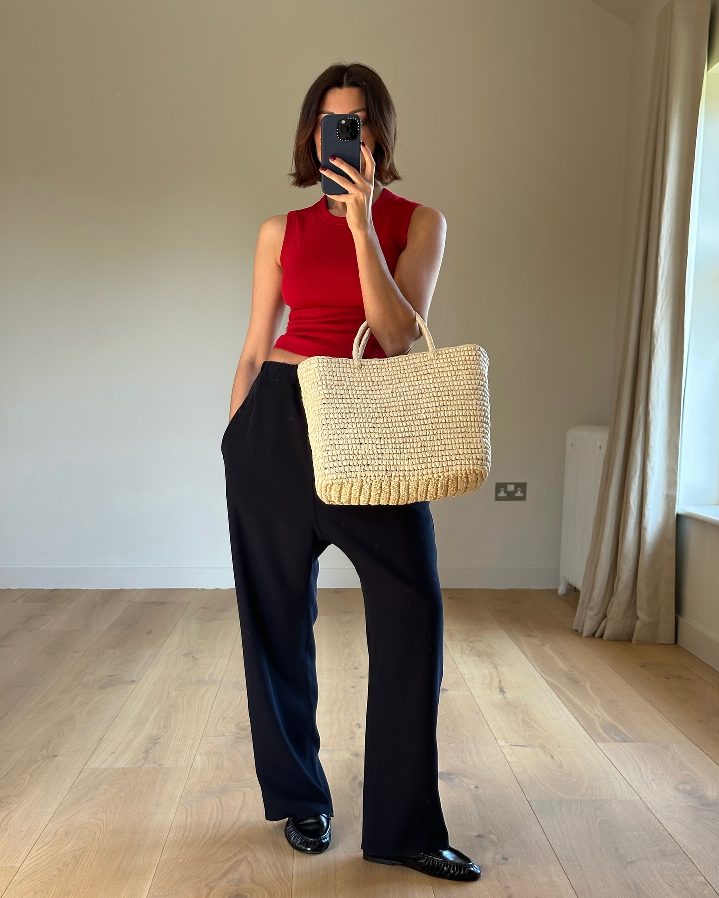 An image of @smythsisters wearing a woven leather bag.