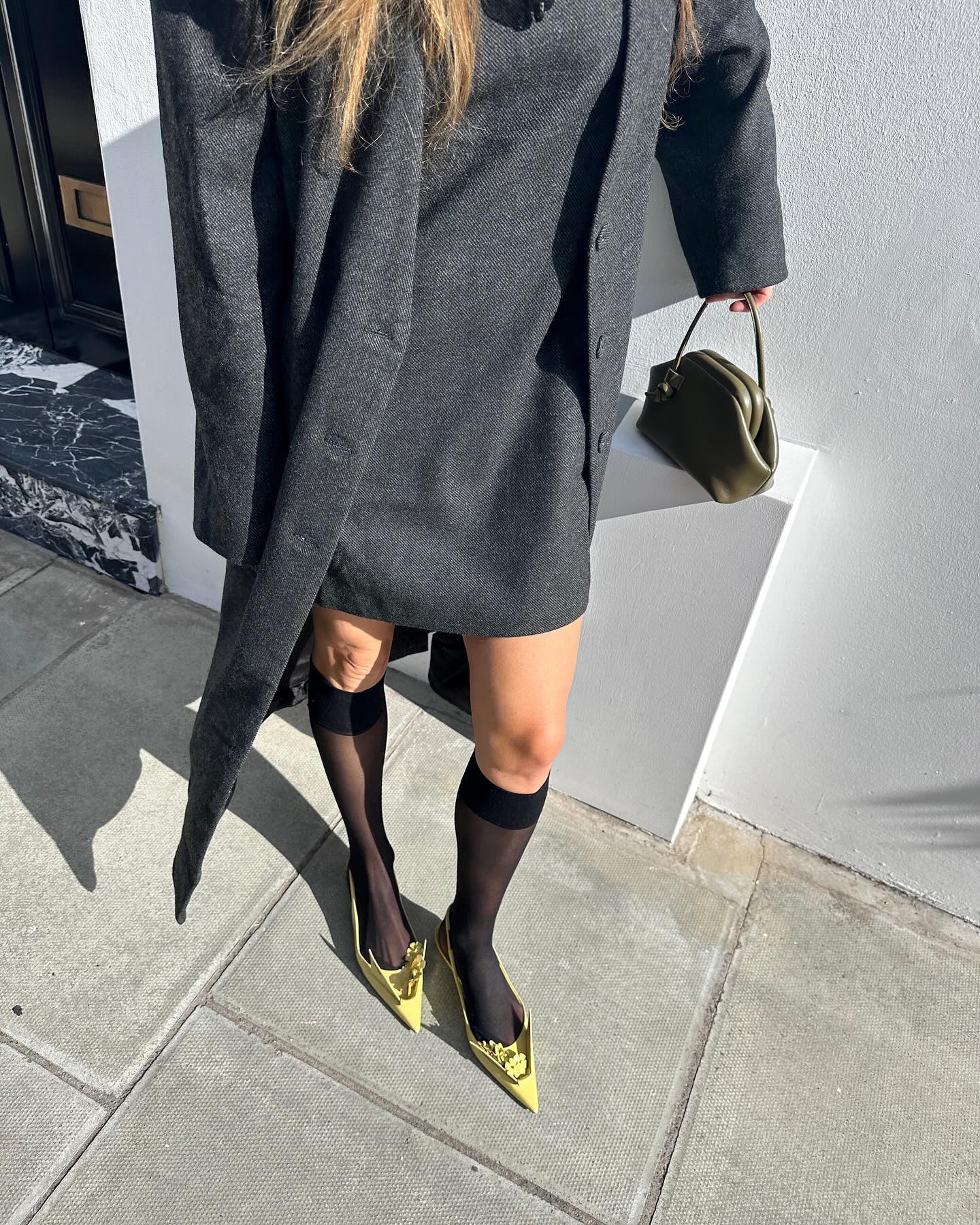 Influencer wears yellow heels.