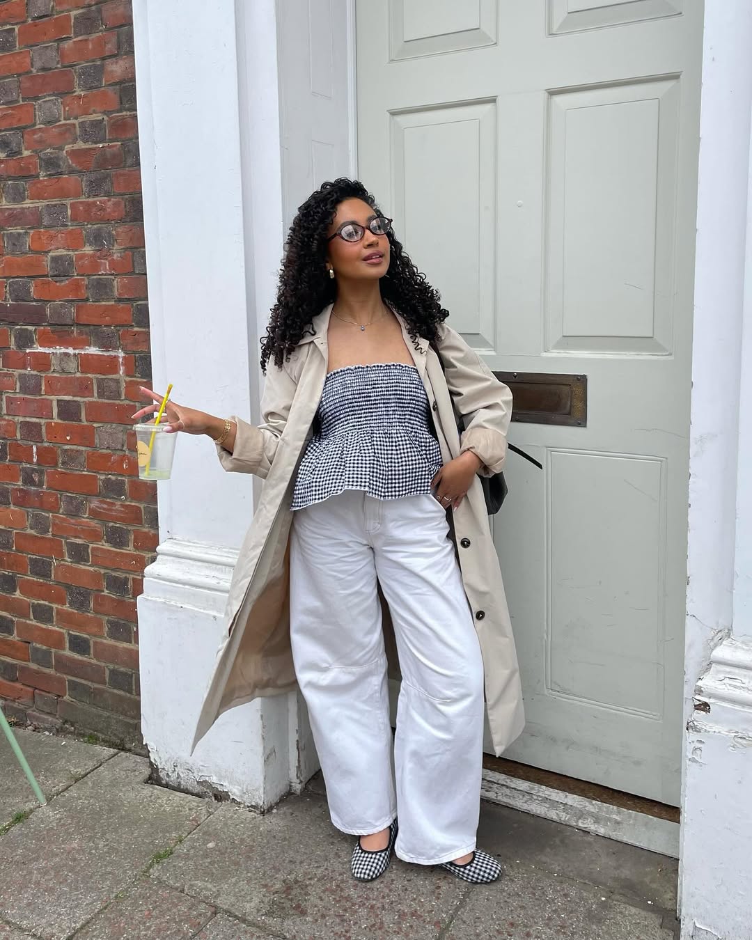 Layla in white jeans and gingham top with trench coat