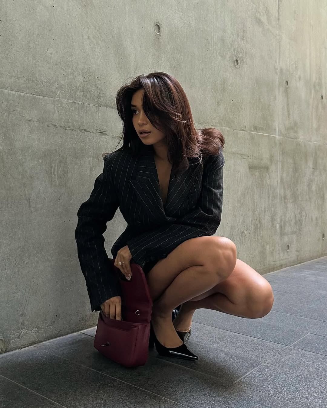 Woman bending down to get something out of her purse.