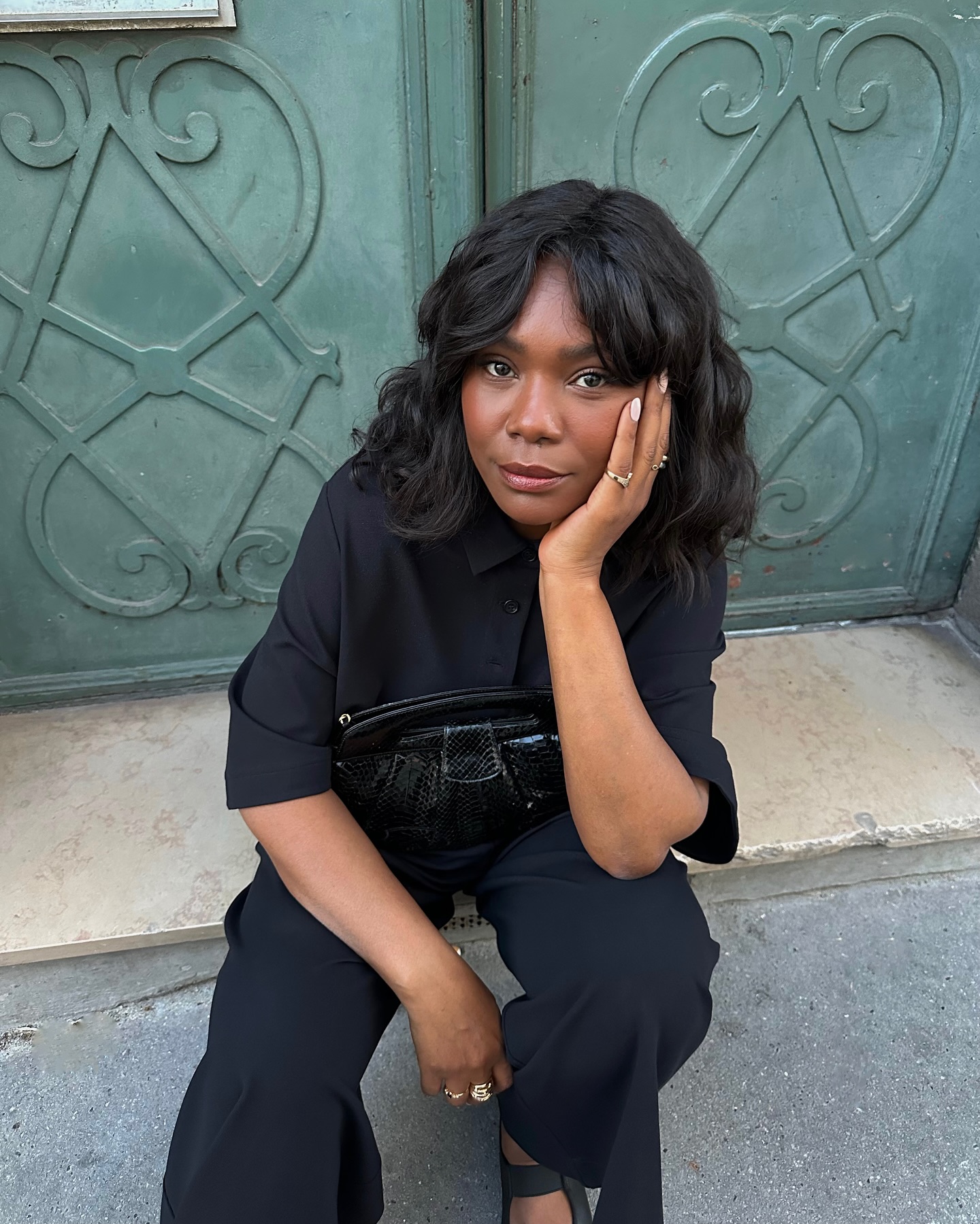 Franny with draped bob wearing navy shirt and trousers