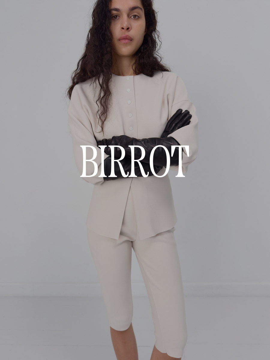 A photo of a model wearing a cream sweater and pedal pushers set. Text says "Birrot" in white capital serif letters.