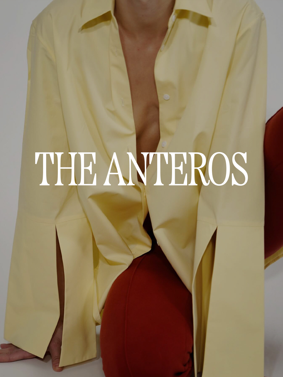 A photo of a model wearing a yellow button-down shirt. Text says "The Anteros" in white capital serif letters.