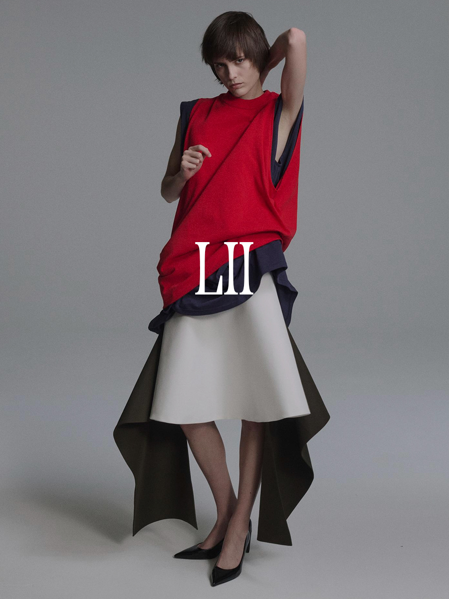 A photo of a model wearing a Lii red top, gray dress, and white skirt. Text says "Lii" in white capital serif letters.