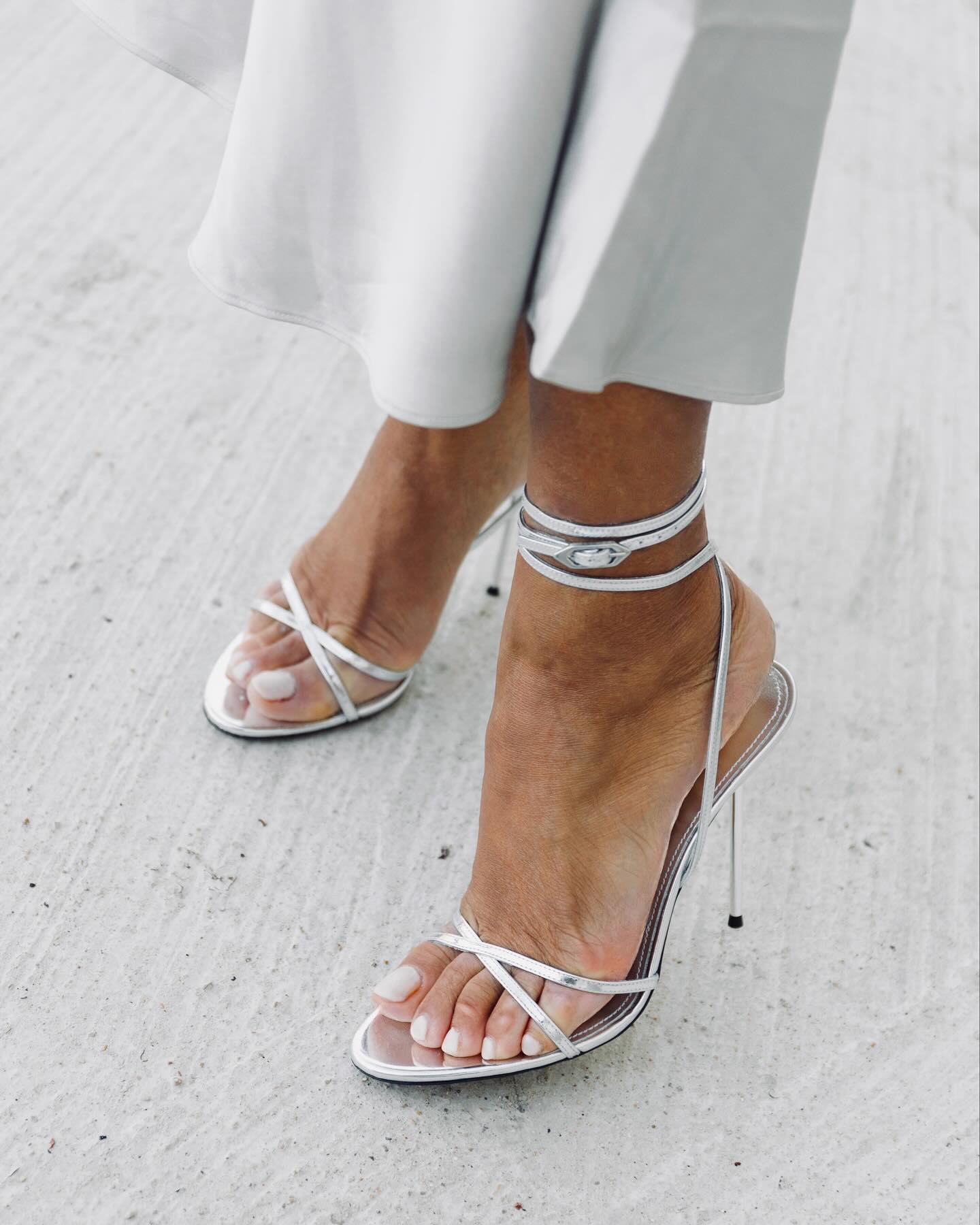 @slipintostyle wearing silver heels with a milky pedicure