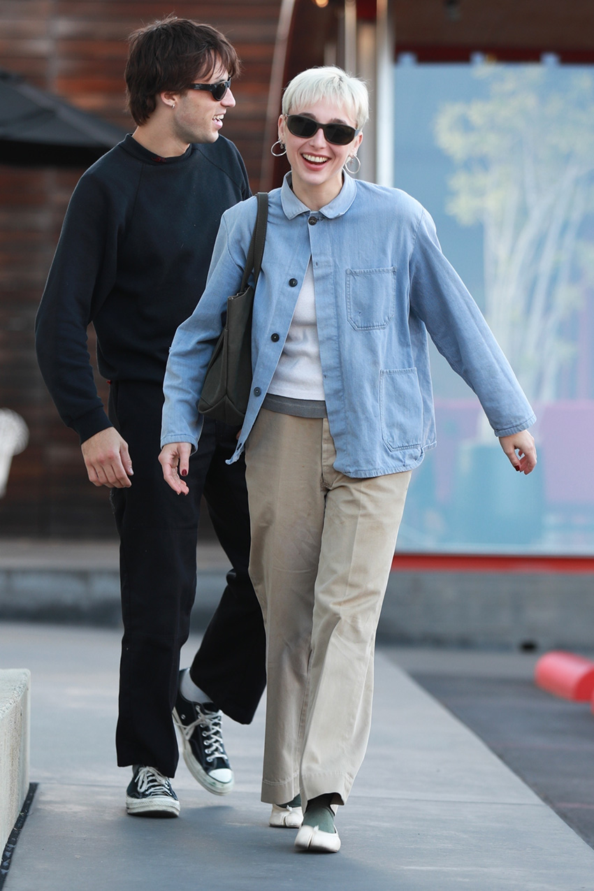 Emma Chamberlain wearing a denim chambray jacket, khaki pants, and Tabi ballet flats