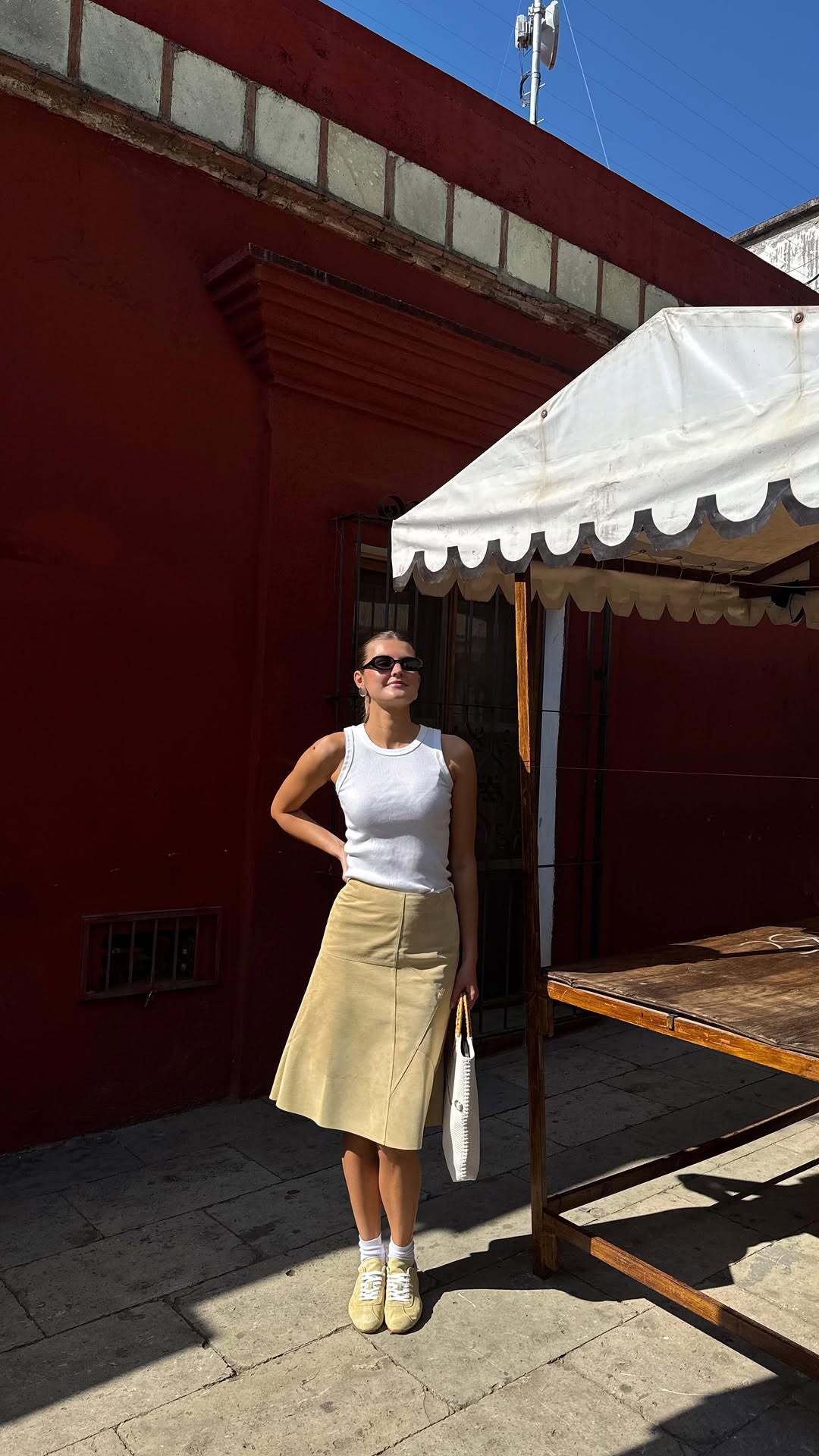 Influencer wears butter yellow sneakers.