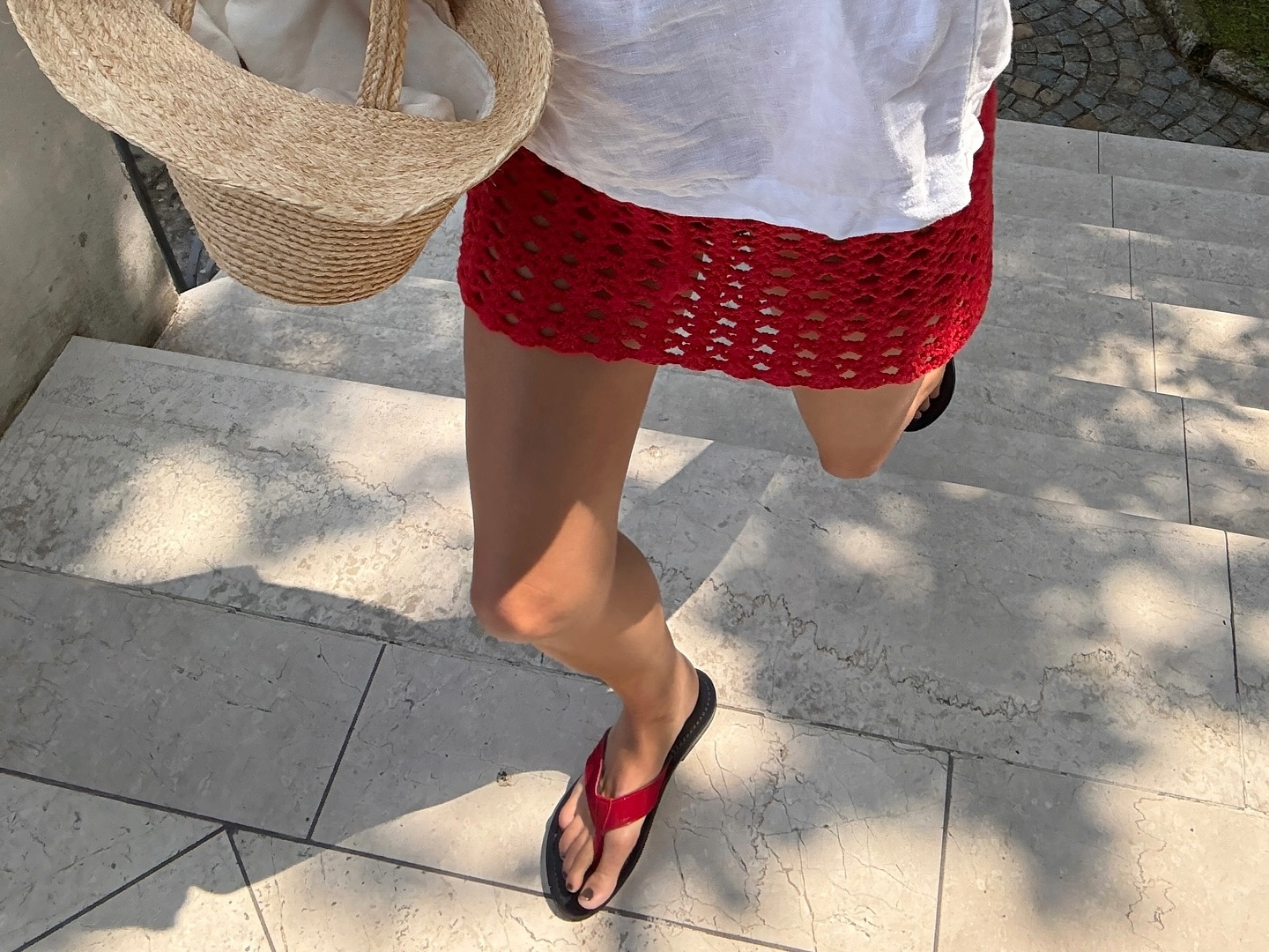 Lucy Williams wearing red flip-flops in Lake Como.