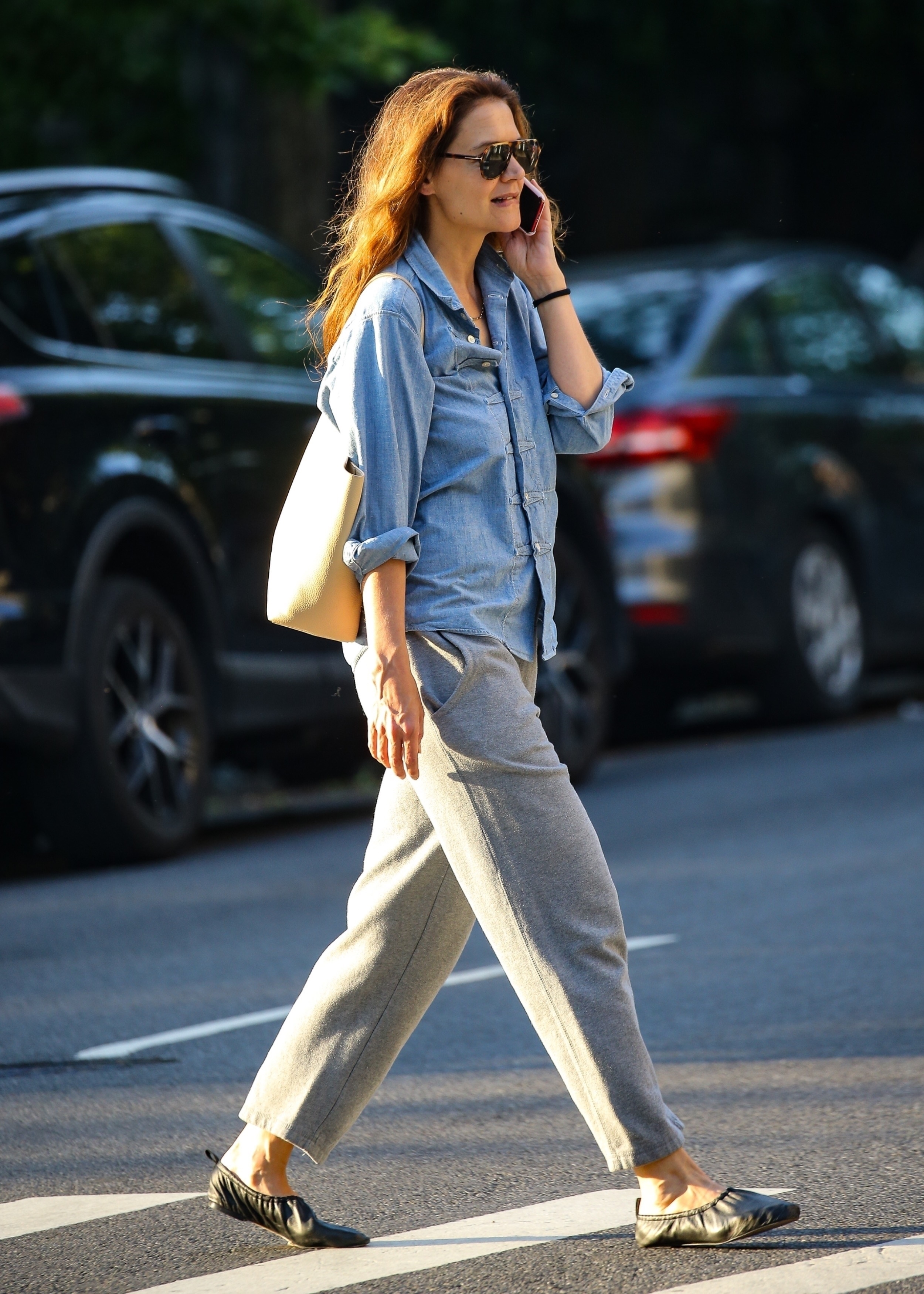 Katie Holmes wears a denim button-down shirt, gray sweatpants, black ruched ballet flats.