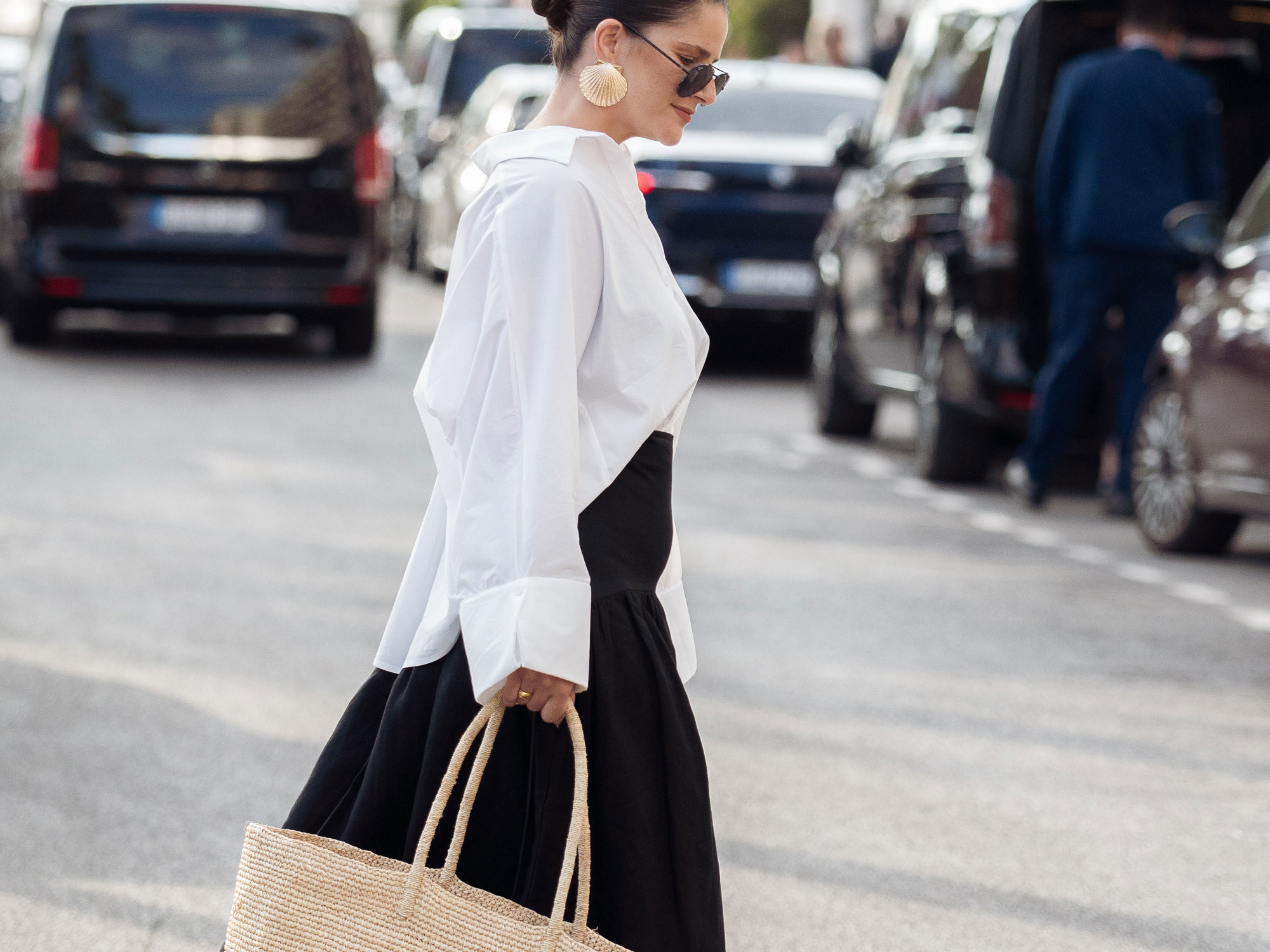 a woman wears a white shirt and a black skirt