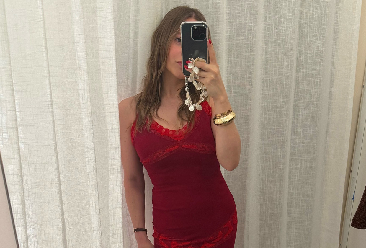 Nikki wears a maxi red dress with lace trim.