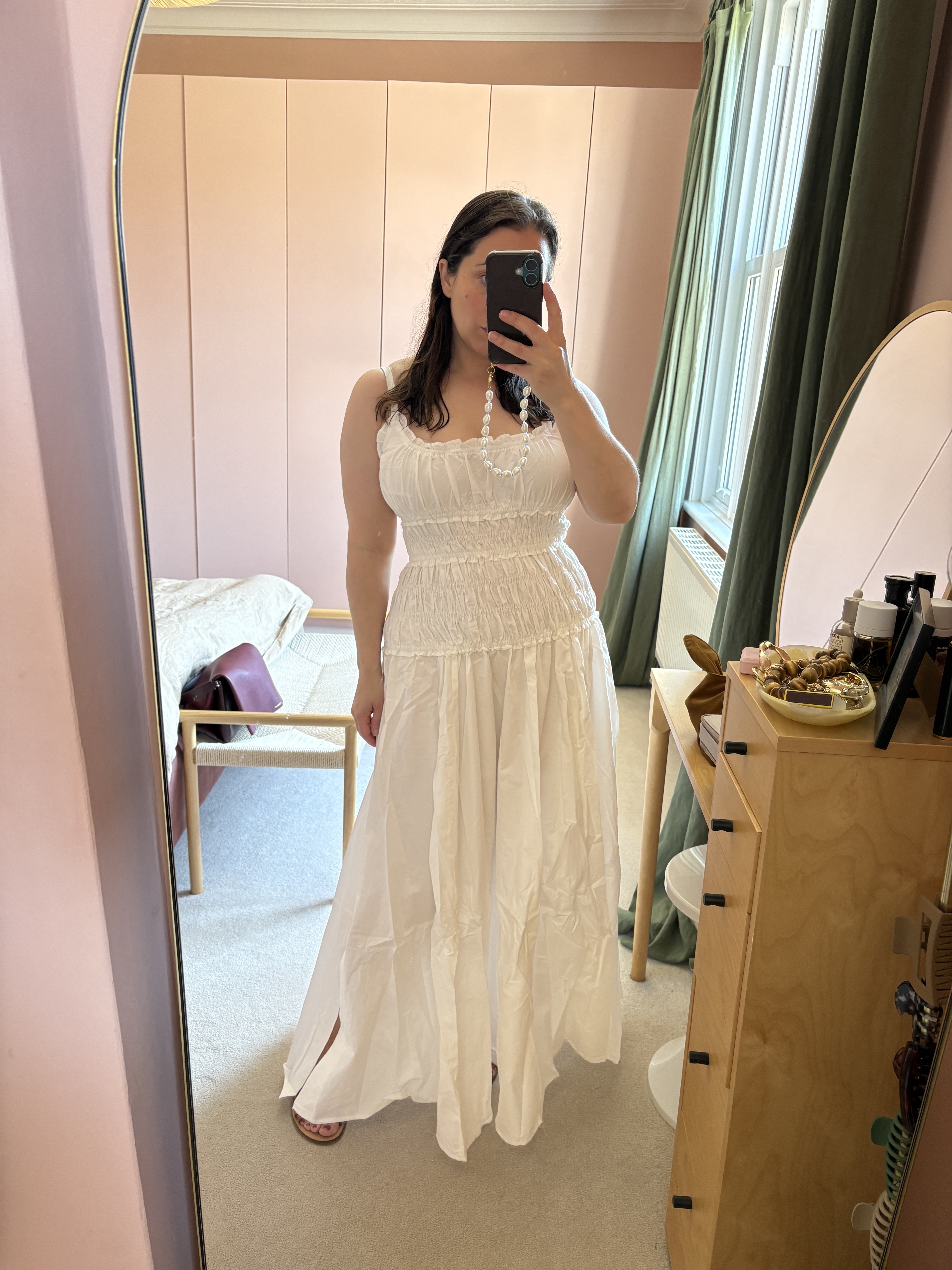 An image of Who What Wear editor in chief @hannahalmassi wearing a waisted dress from DISSH.