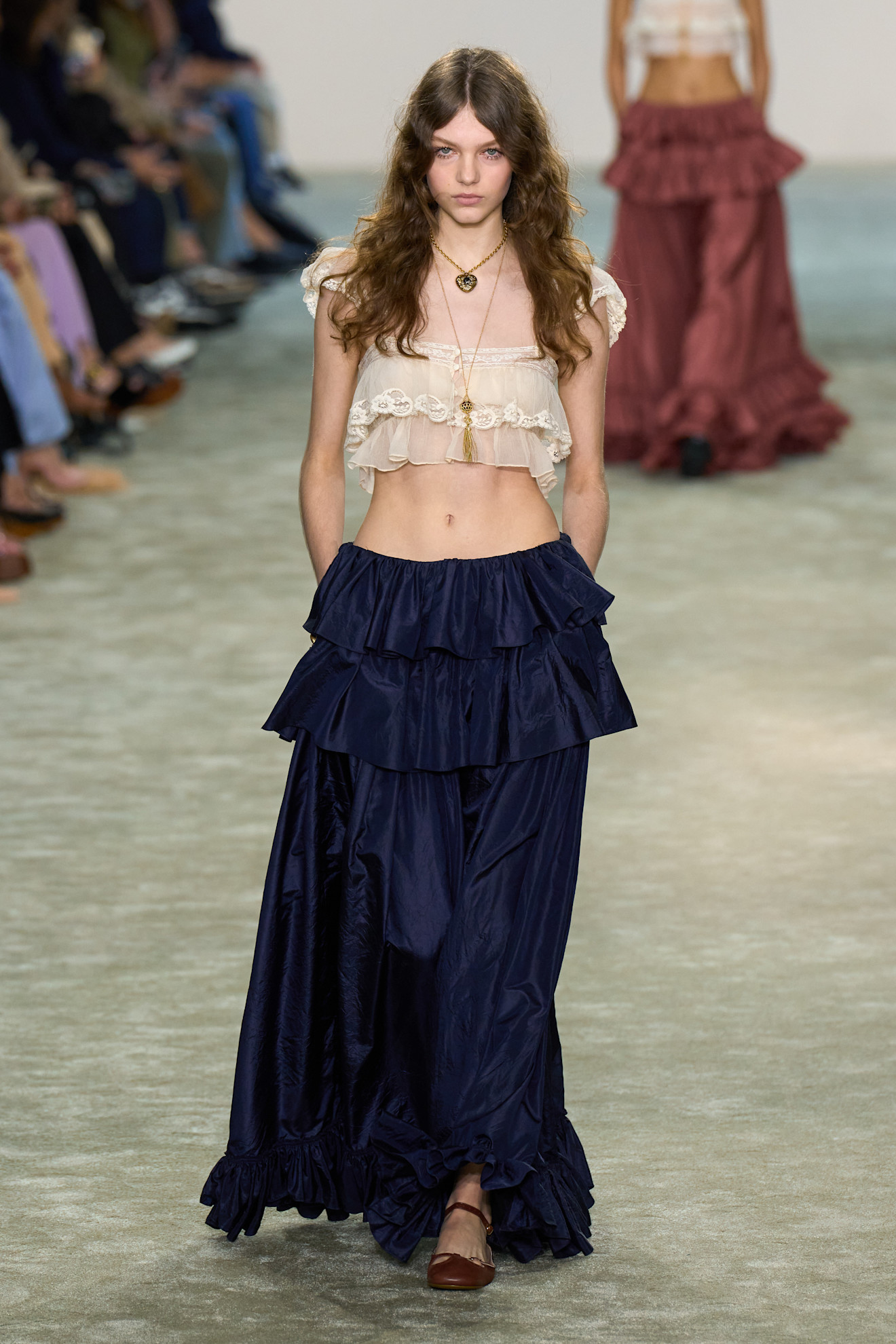 Chloe fall/winter 2025 a women wears a lace trim top and maxi skirt.