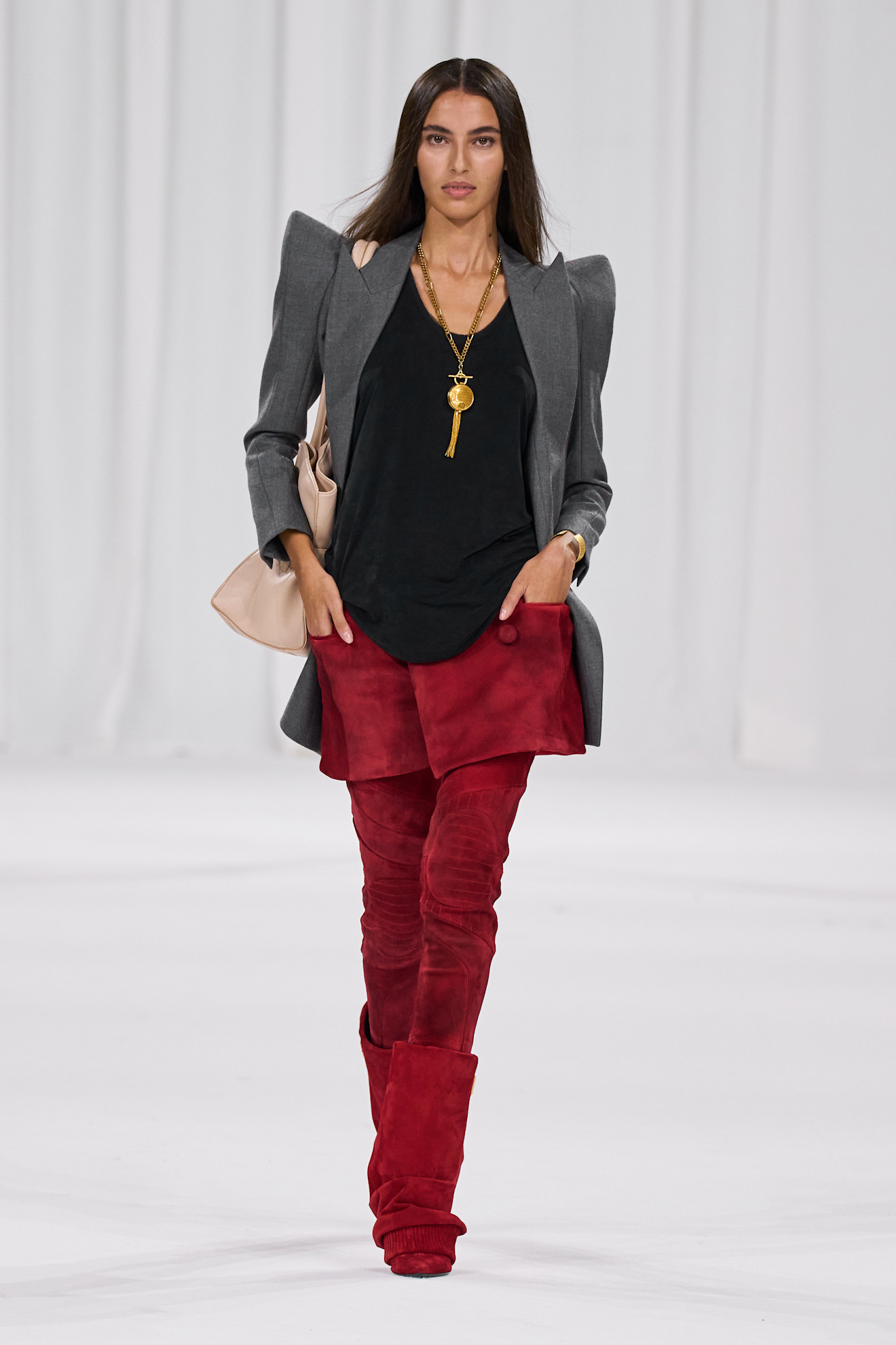 A woman wears tassel accented necklace on the balmain s/s 25 runway.