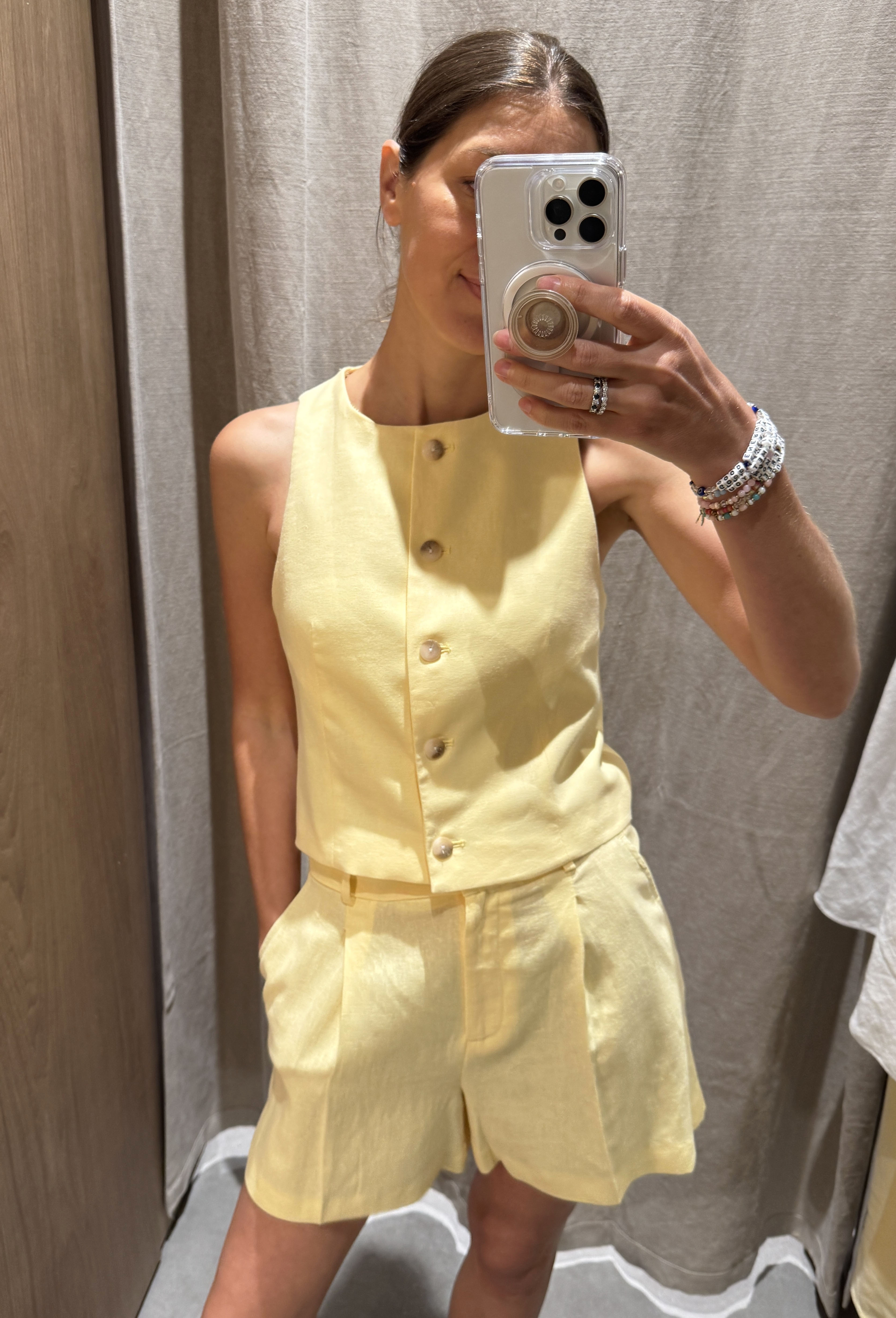 Woman in yellow vest and shorts