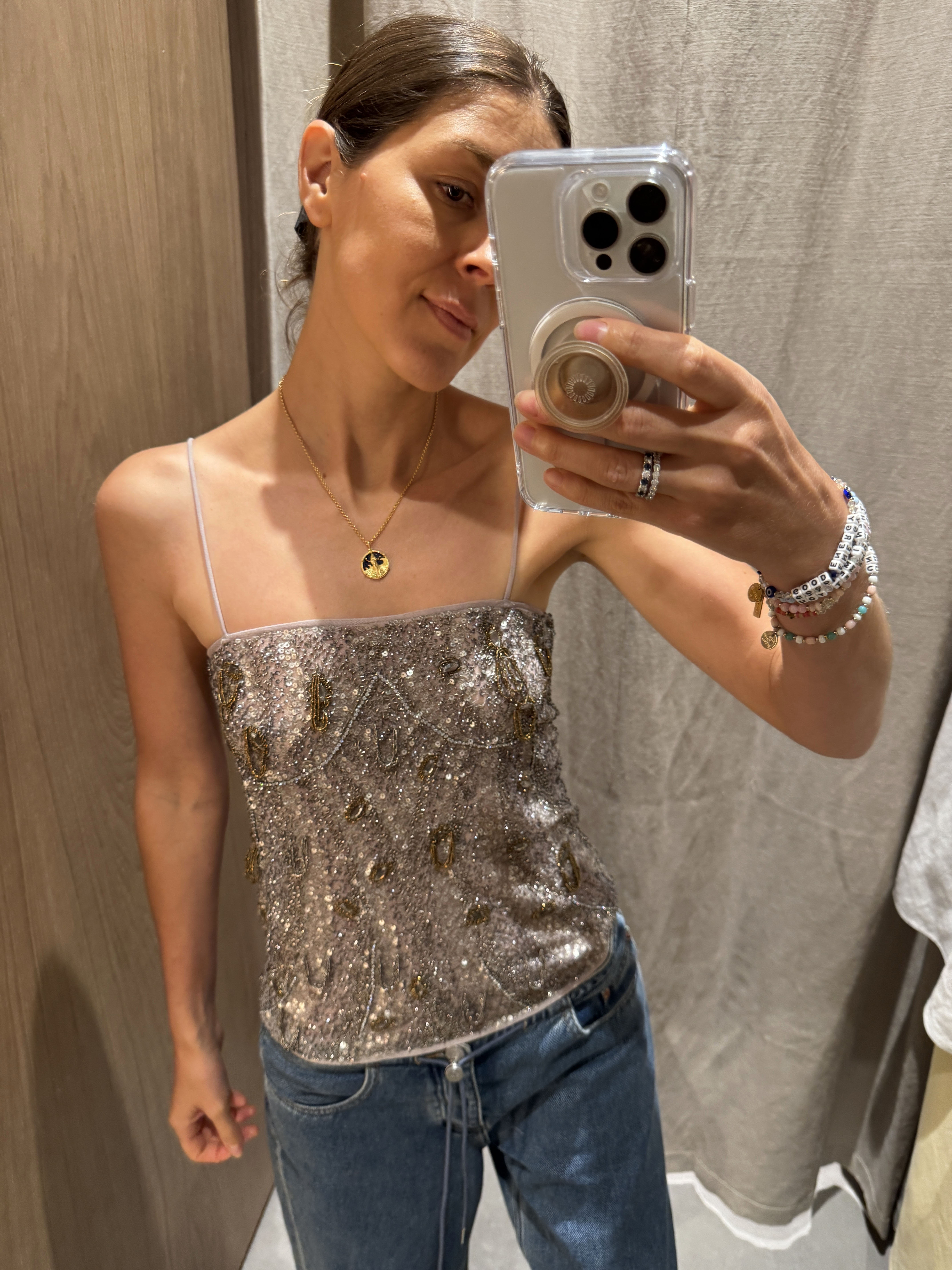 Woman in sequin top and jeans