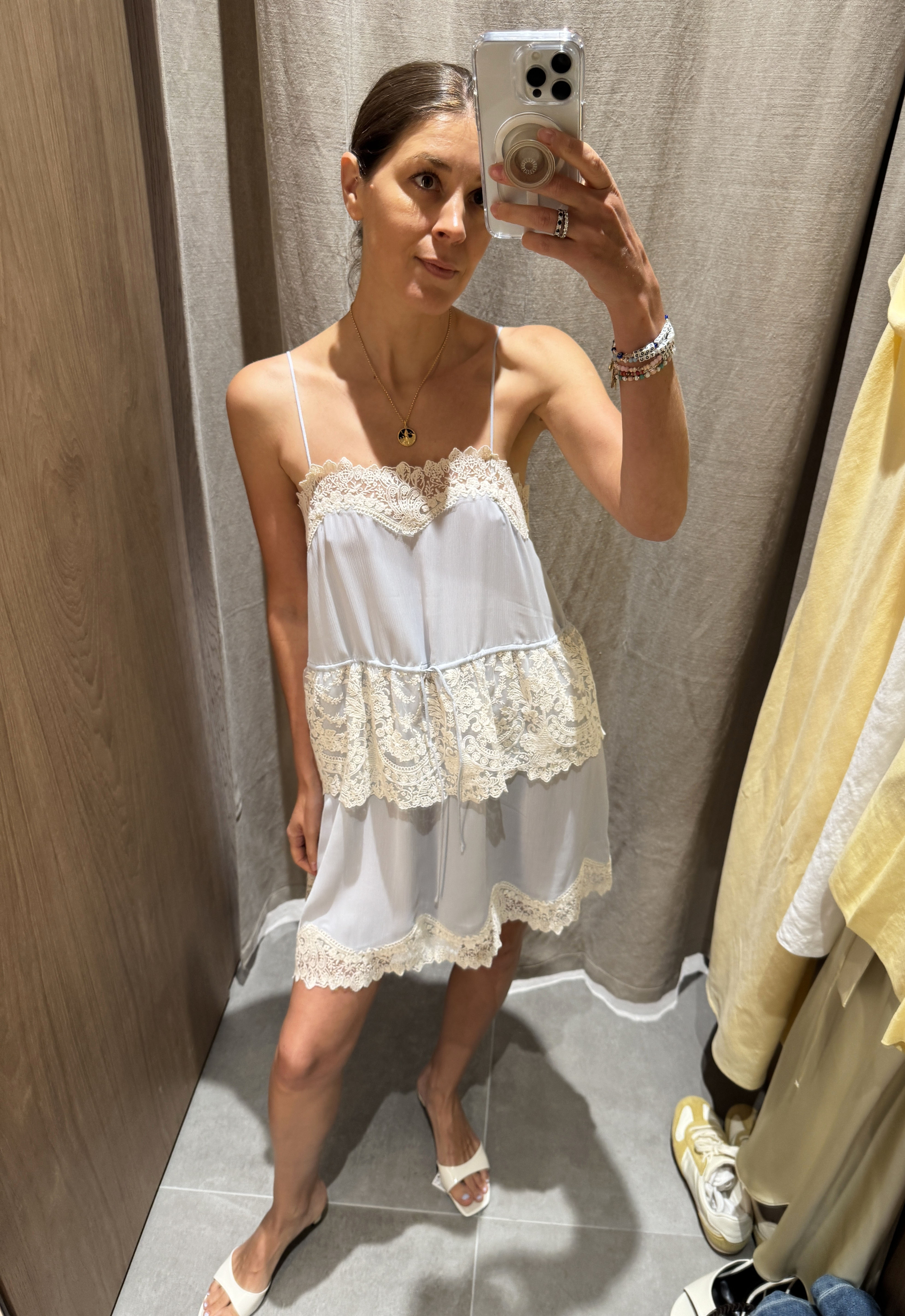 Woman in pale blue and lace dress