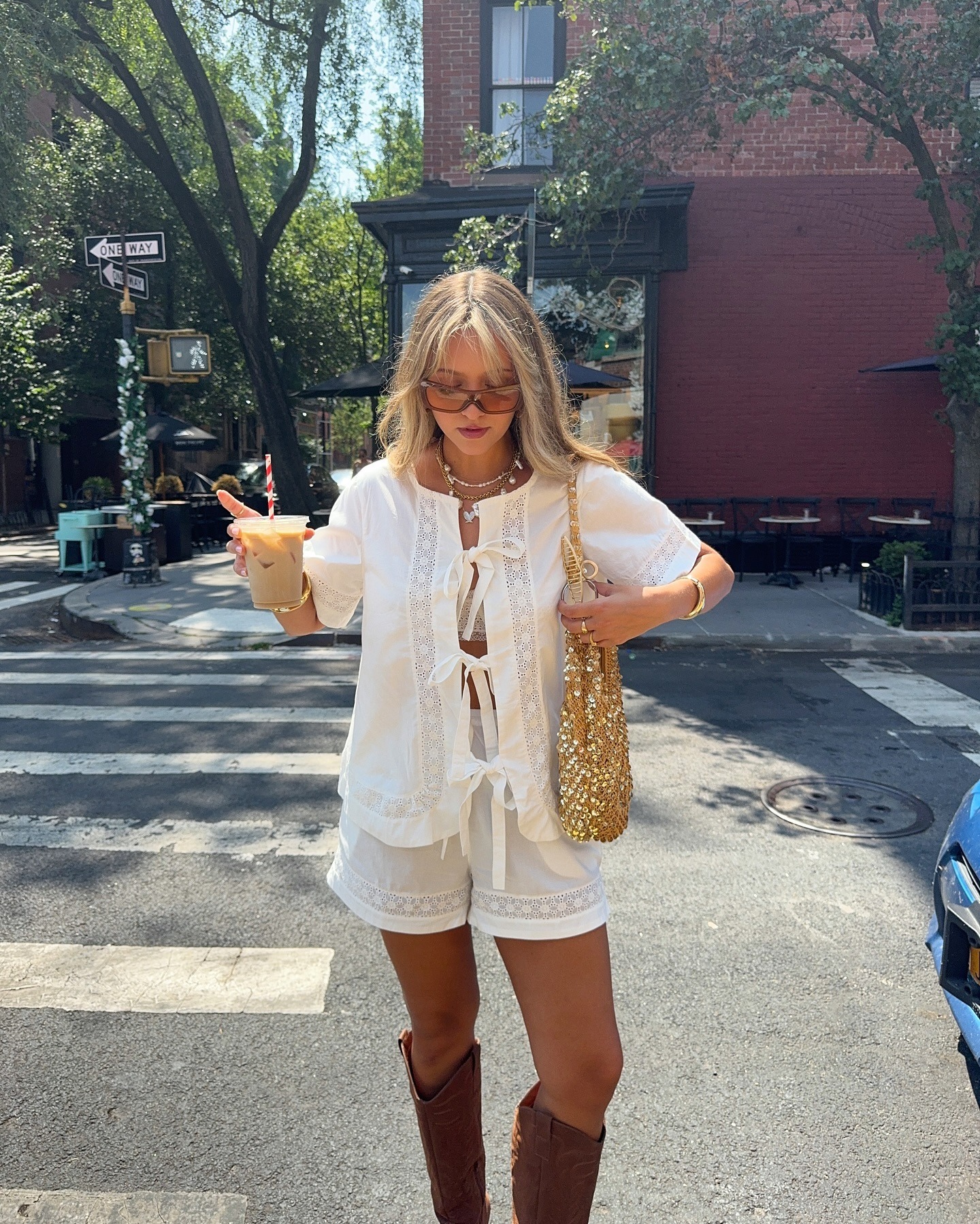 A woman in New York wearing a white two piece set with creamy blonde hair