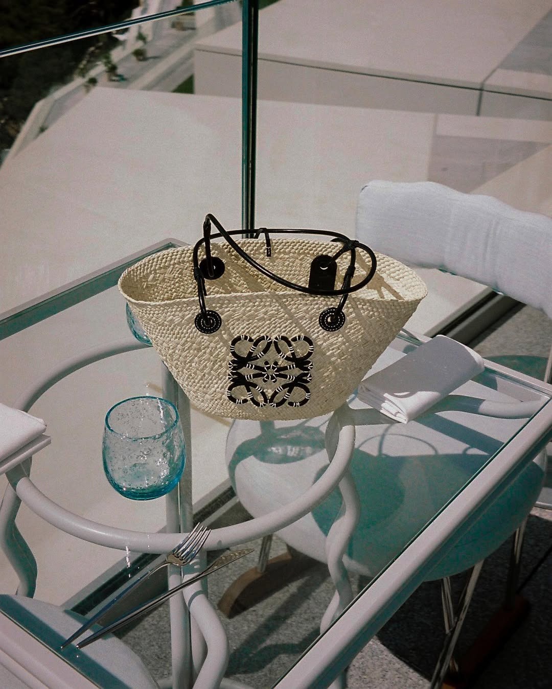 Loewe anagram basket bag on a glass table