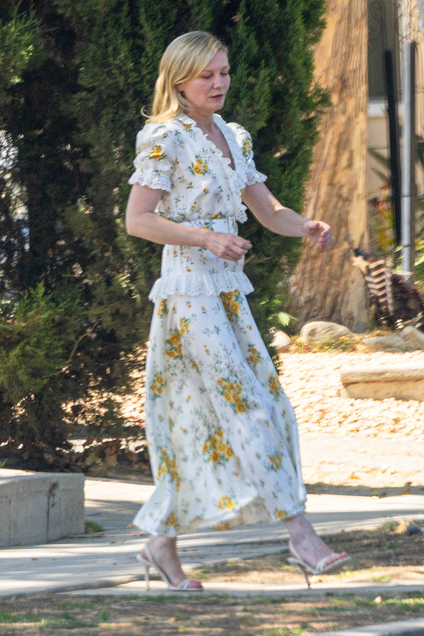 Kirsten Dunst wearing a white Rodarte dress to a wedding