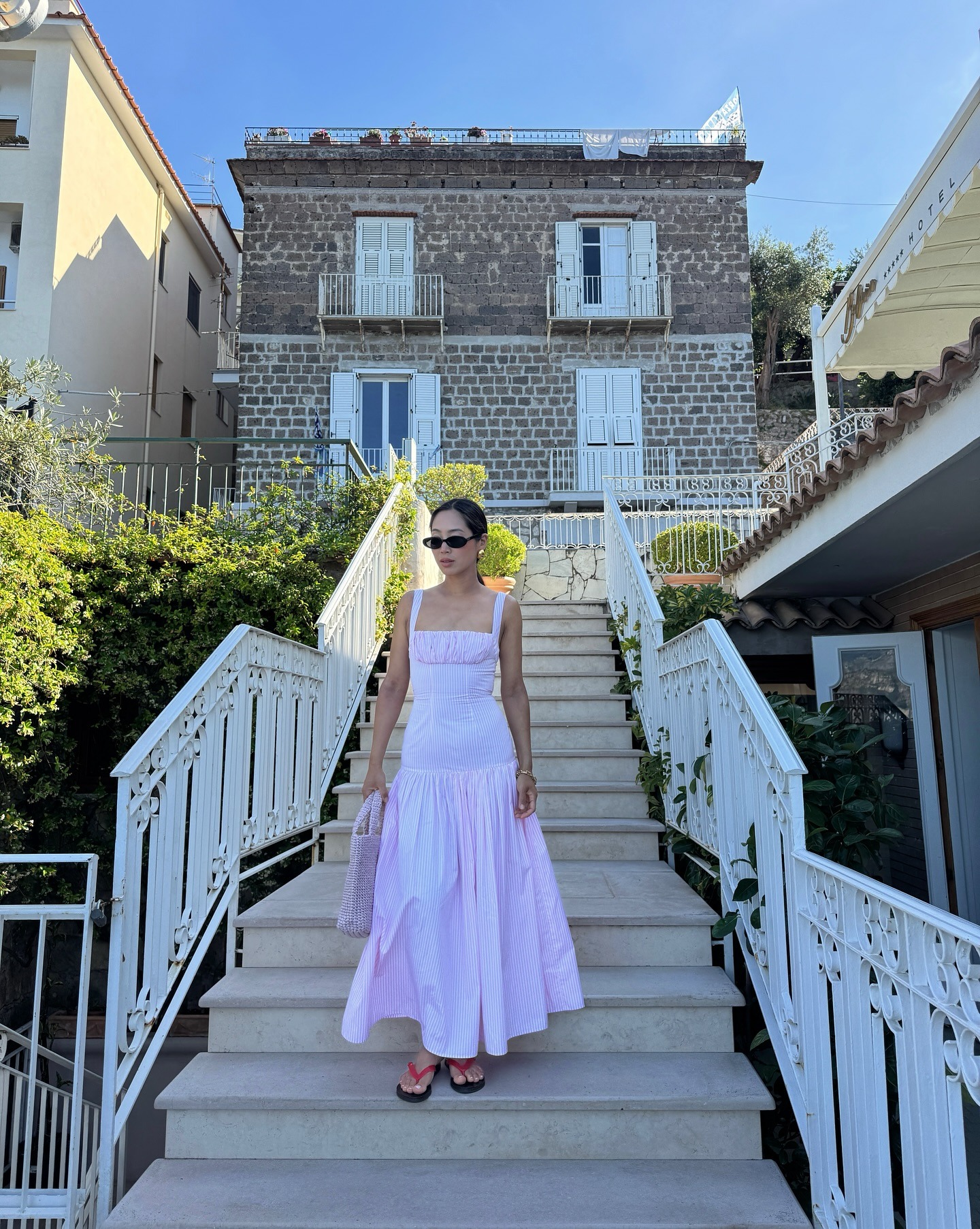 Influencer wearing a maxi dress and sandals in Italy