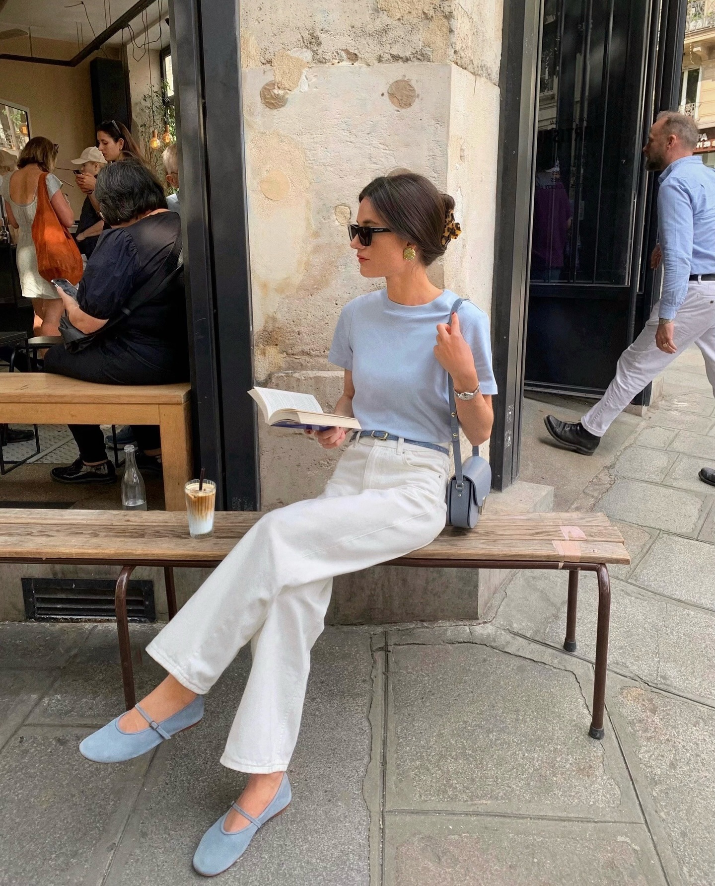 French influencer wearing a blue top and shoes with white jeans