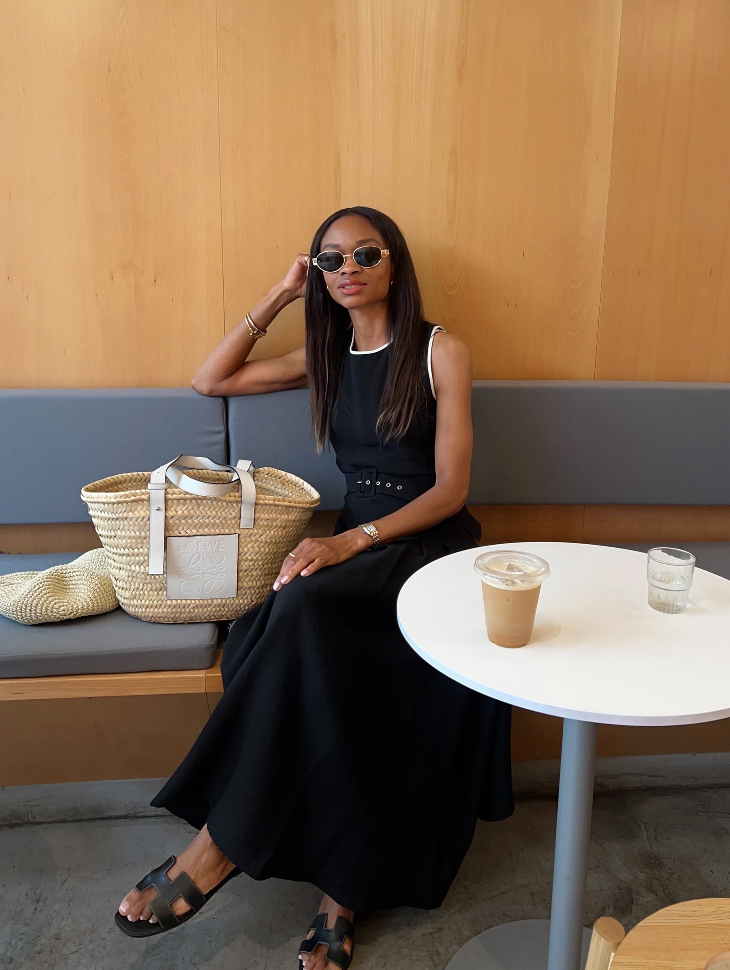 @symphonyofsilk wears a black dress with a full skirt and carries a basket bag