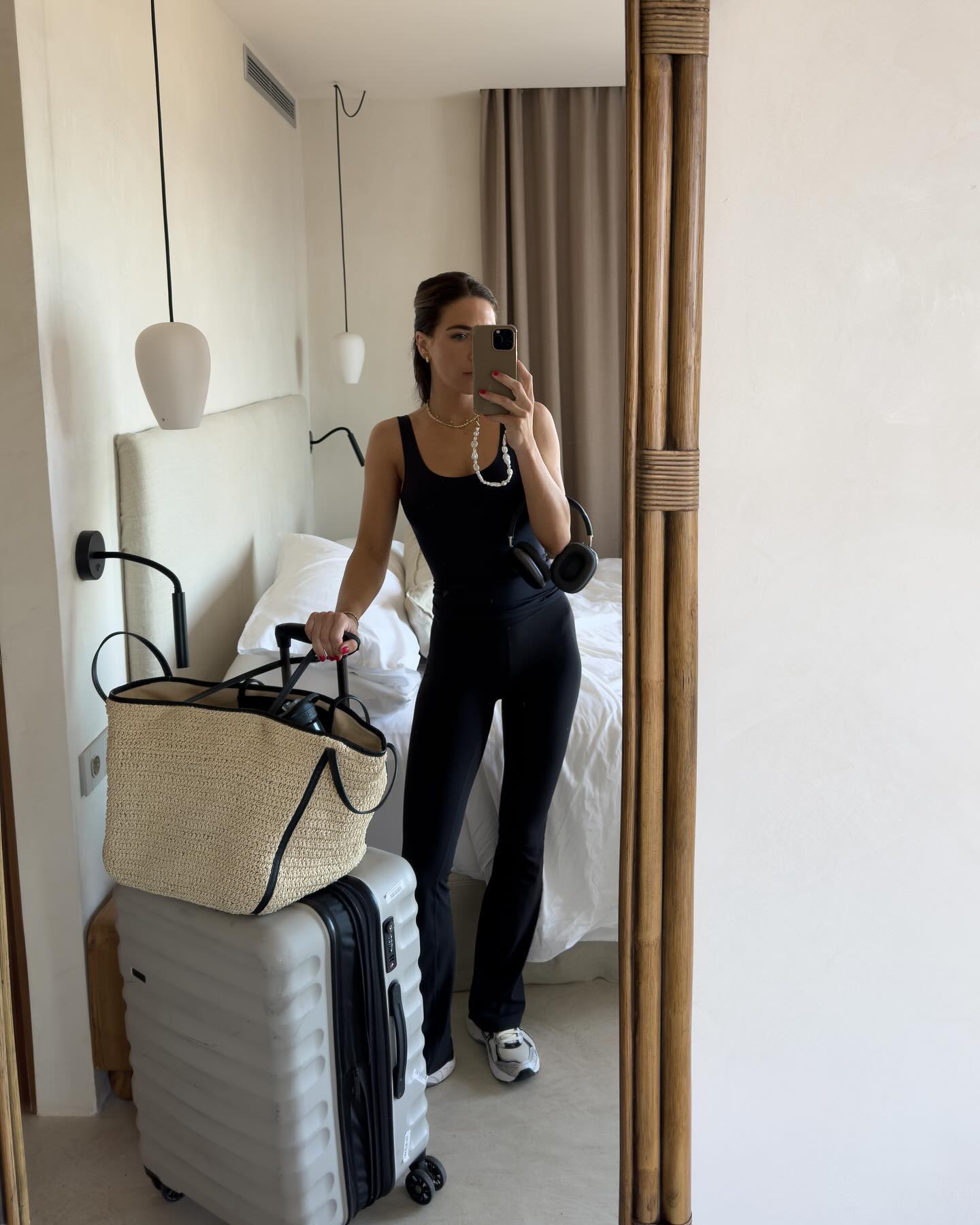 @_jessicaskye wears leggings, trainers and a strappy top to go to the airport