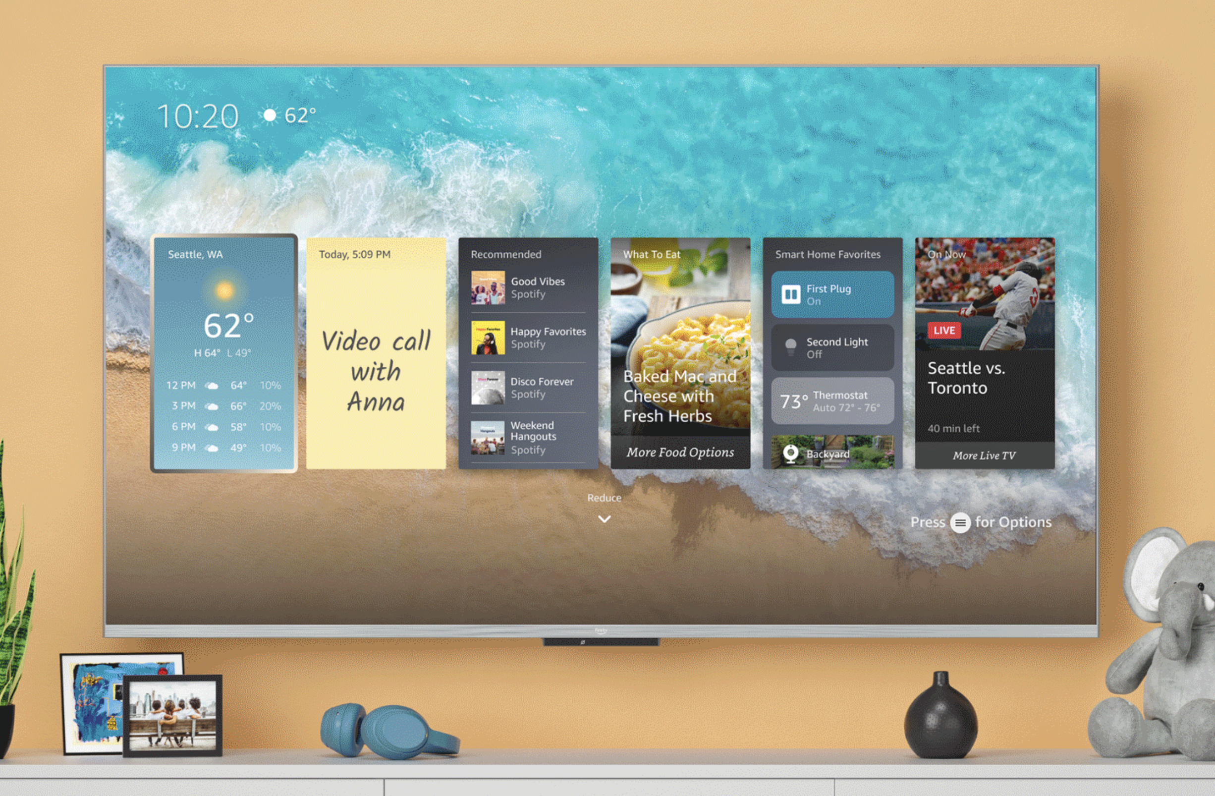 An image of Amazon’s Fire TV Omni QLED television on a wall with onscreen widgets for weather, sticky notes, music, and more.