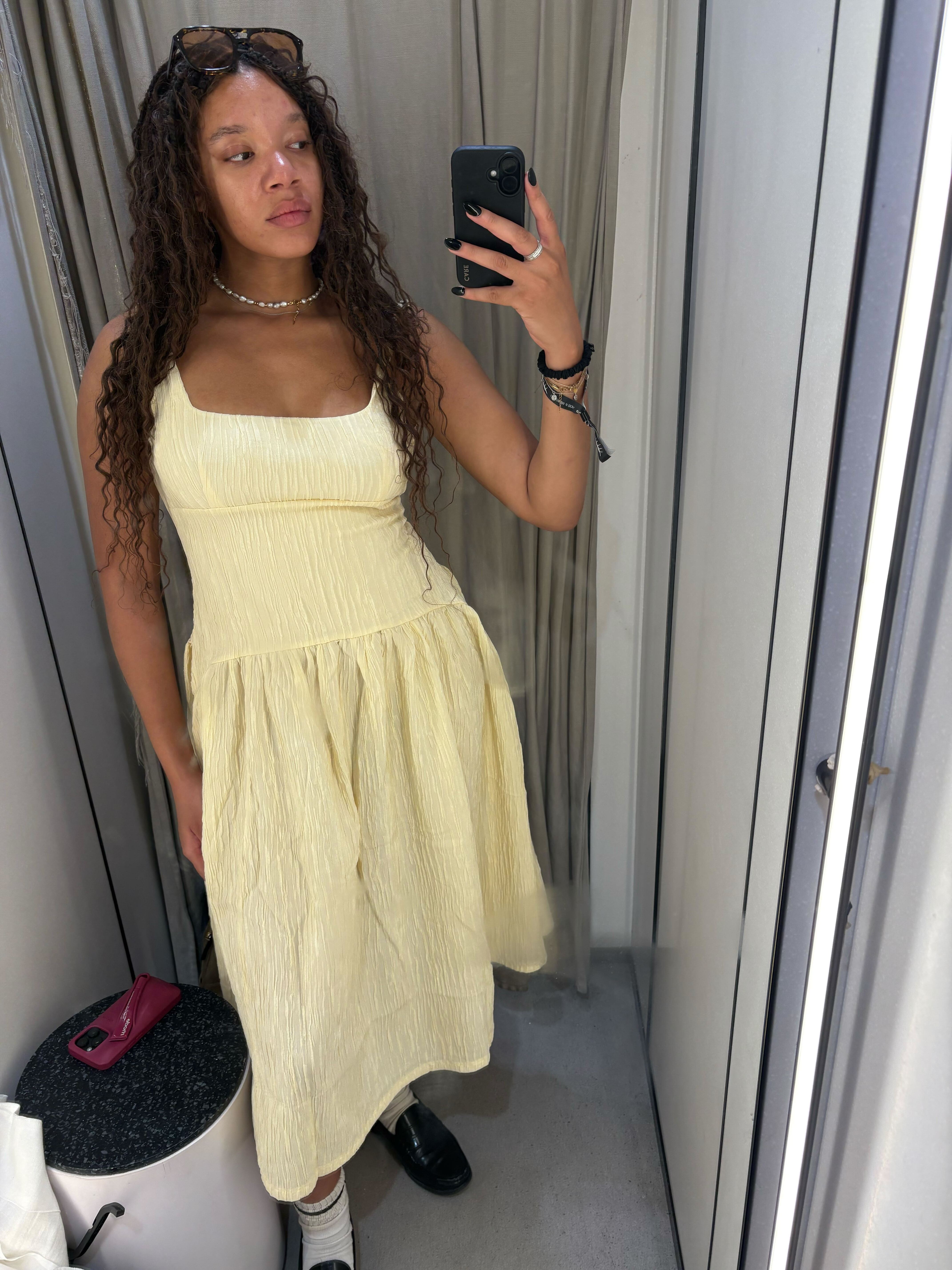 Imani wears the Zara shirred dress in butter yellow in a recent image taken in store in Zara Oxford Circus.