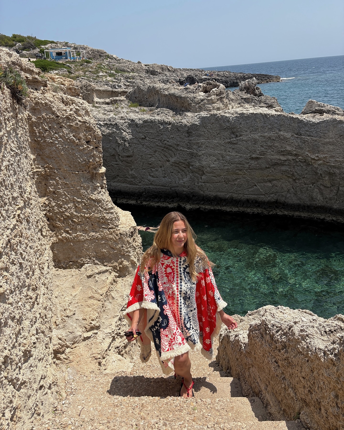 An image of @oliviamarcus wearing rope sandals with a sarong.