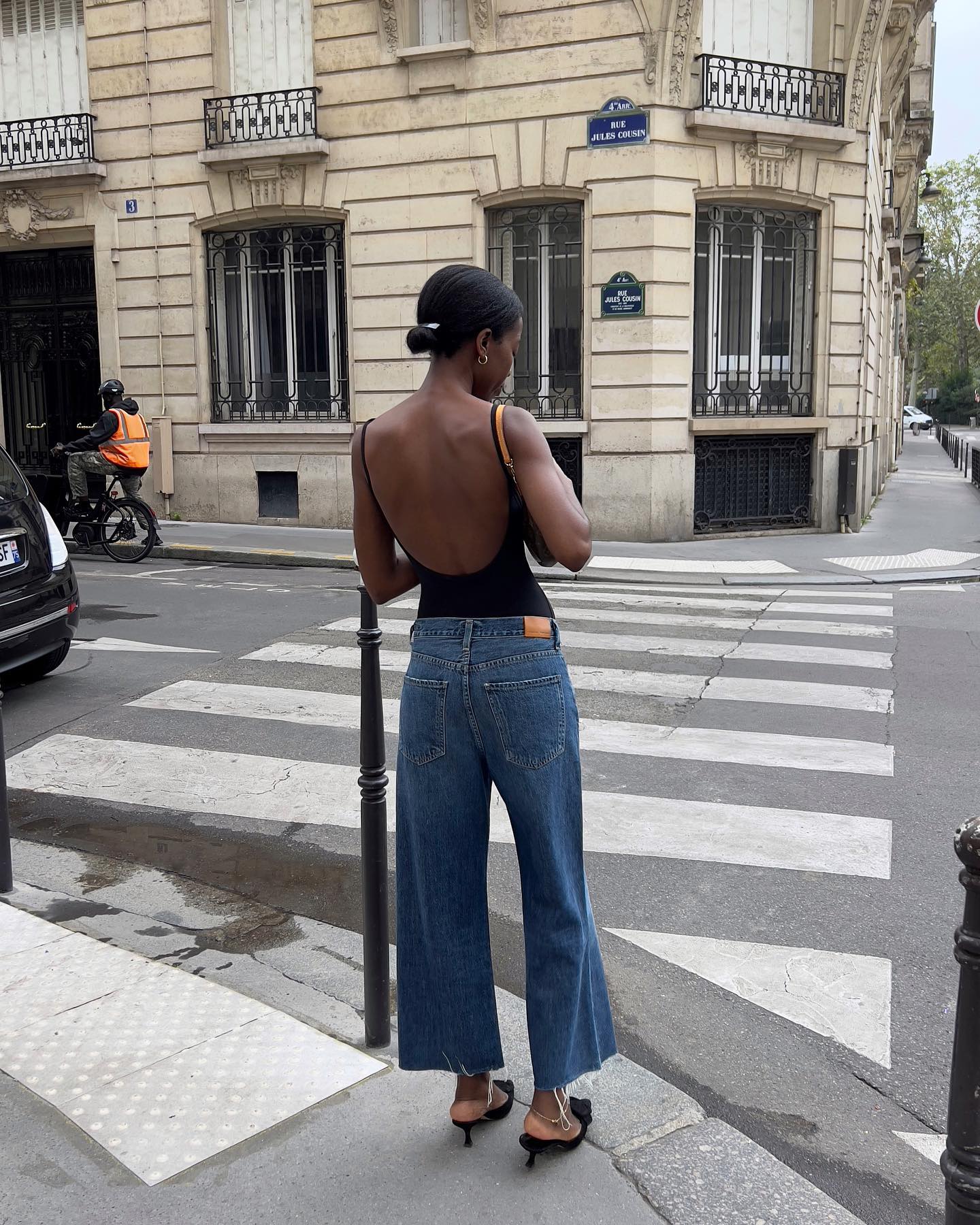 @sylviemus_ wears a pair of cropped wide leg jeans with a backless top