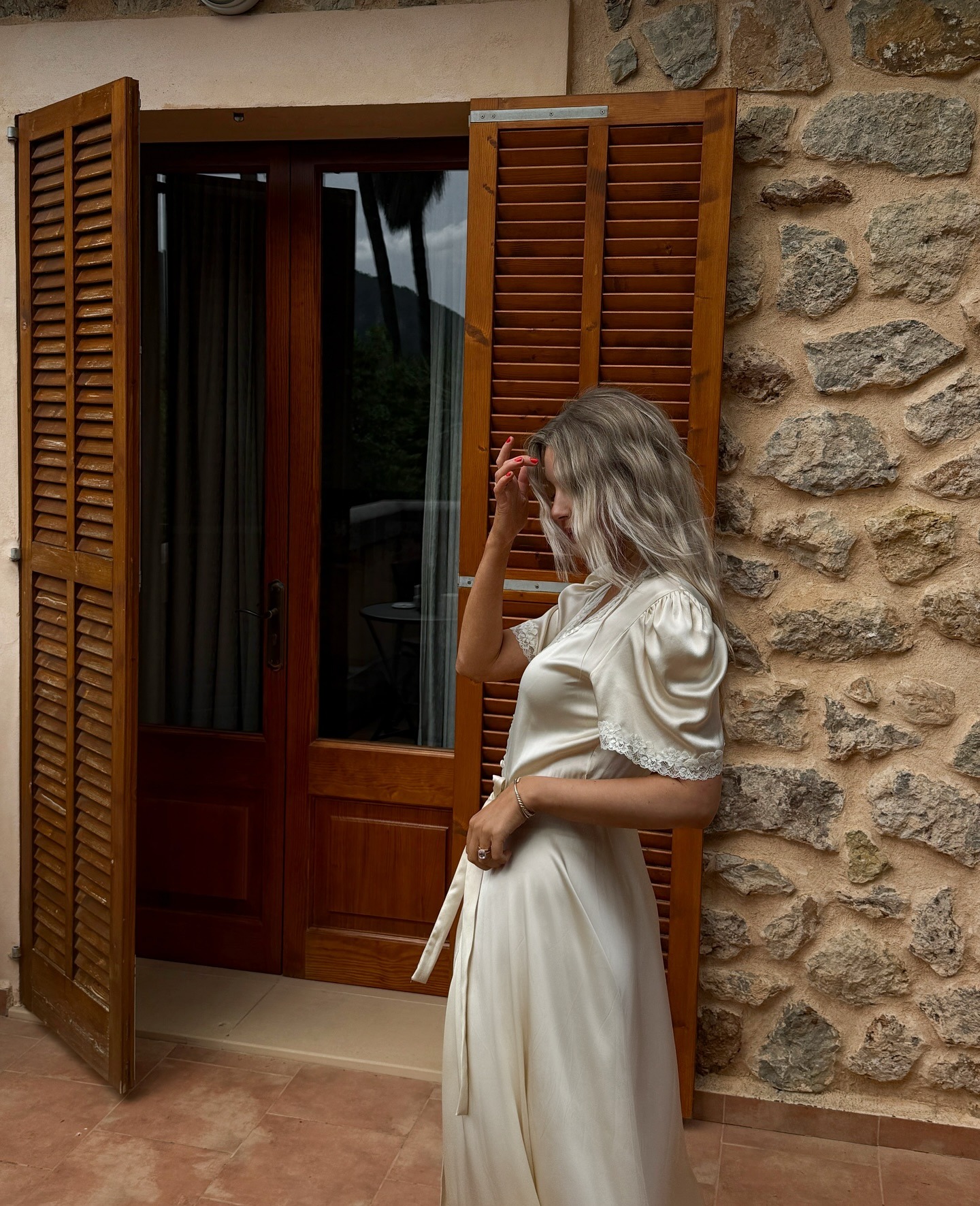 A woman in Mallorca wearing a delicate silk dress