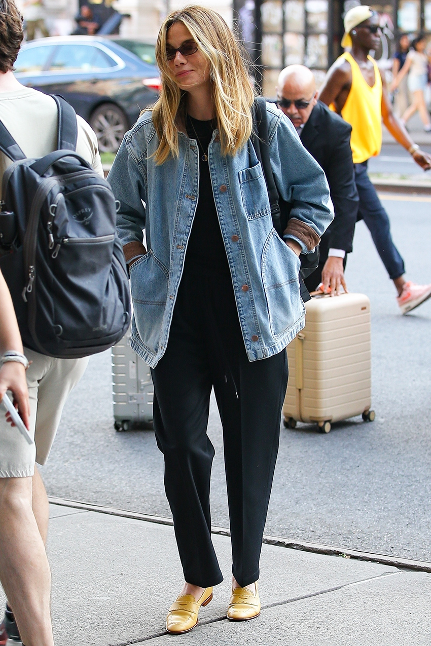 Michelle Monaghan wearing a denim Doen jacket, black tee and pants, and yellow shoes in NYC