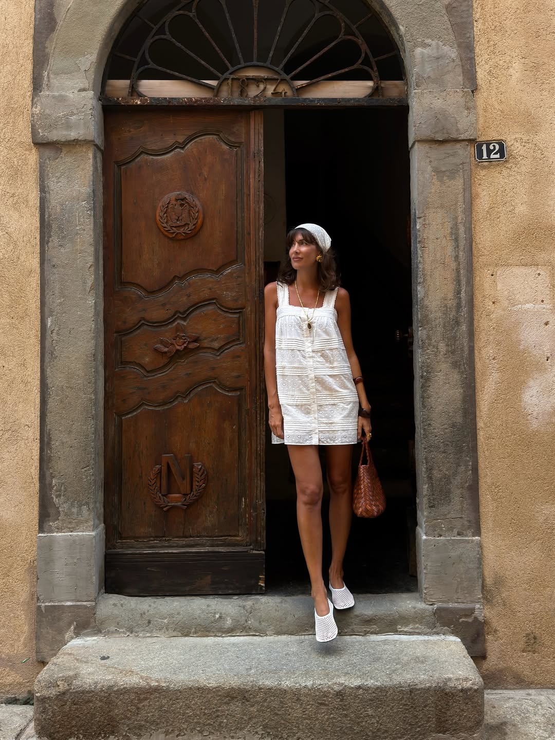 @juliesfi wears a white broderie anglaise dress