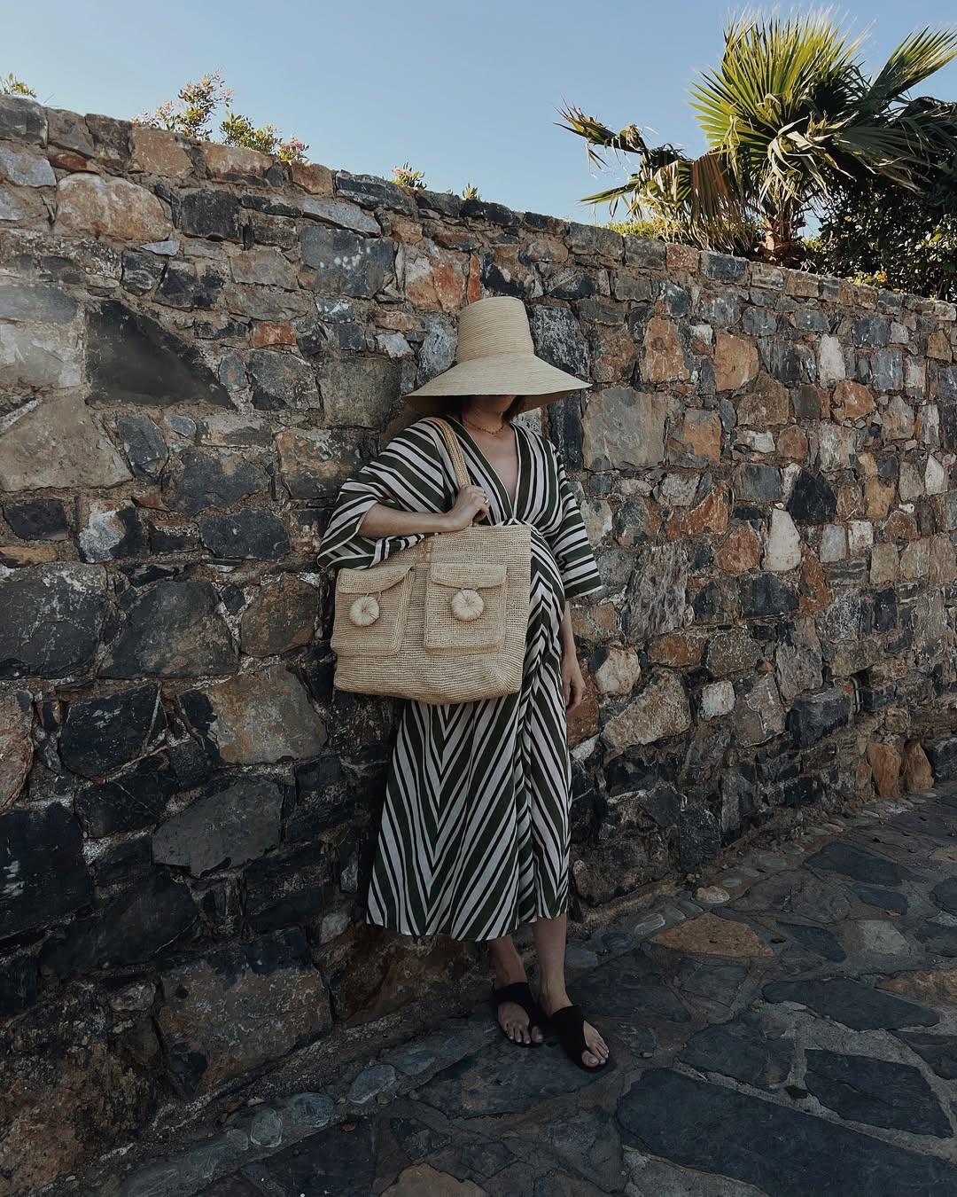 What to wear in Provence outfit ideas - Marissa in striped midi dress and large hat