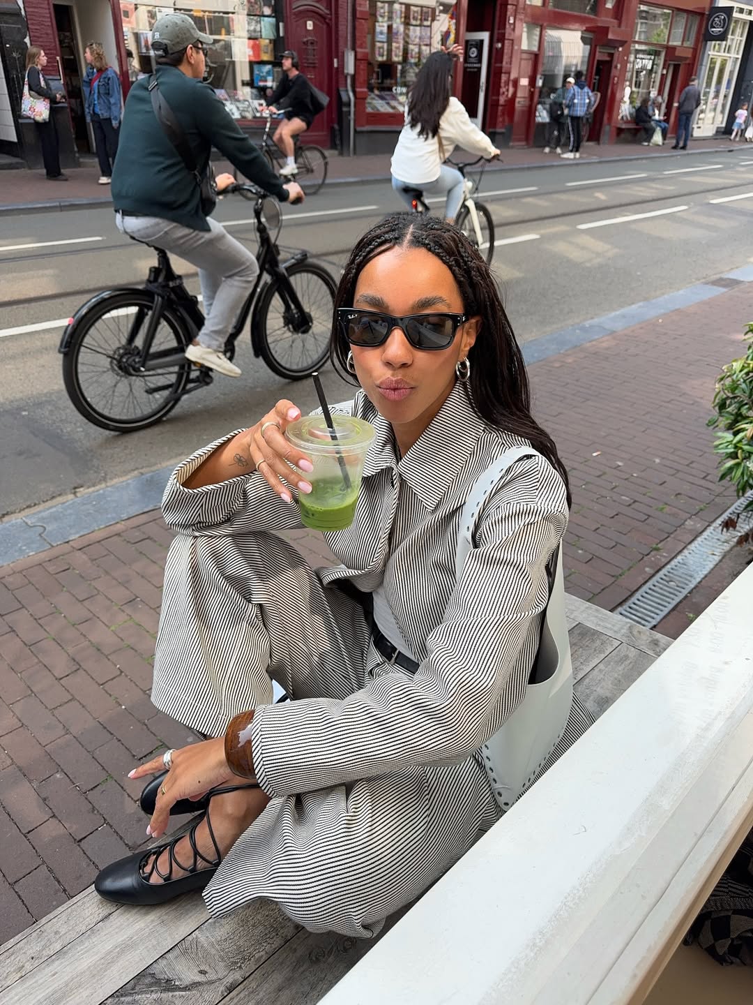 Amaka Hamelijnck drinks matcha while wearing a matching set