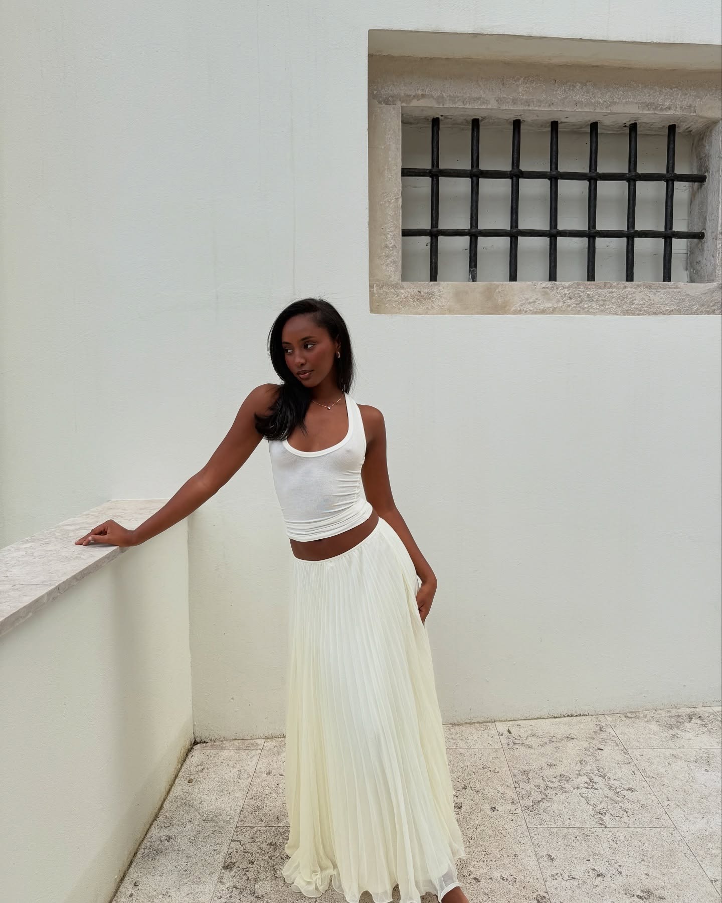 Rayan wears an all-white summer outfit.