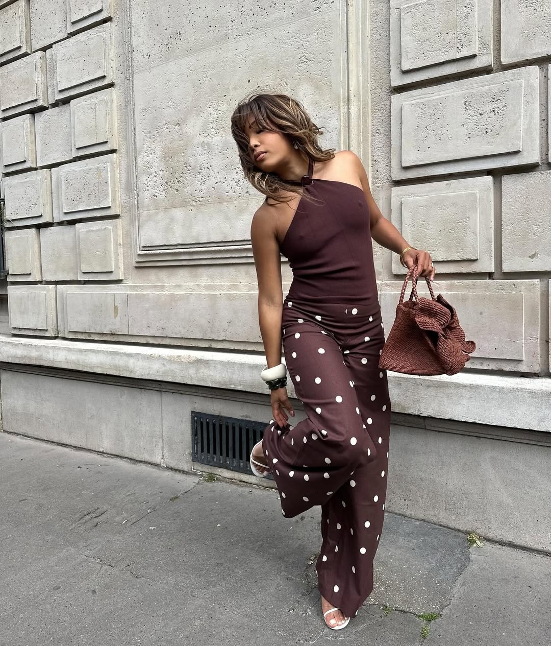 Ellie Nes wearing brown polka-dot pants with a brown halter top