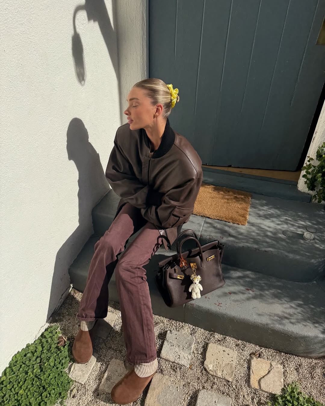 Elsa Hosk wearing brown jeans with a brown bomber jacket
