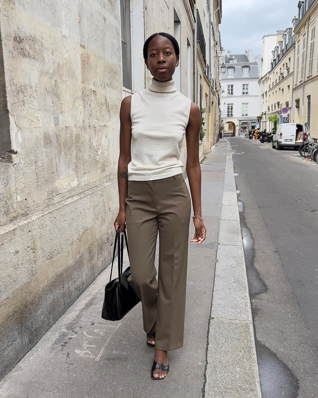 Sylvie Mus wearing brown pants with a cream sleeveless turtleneck