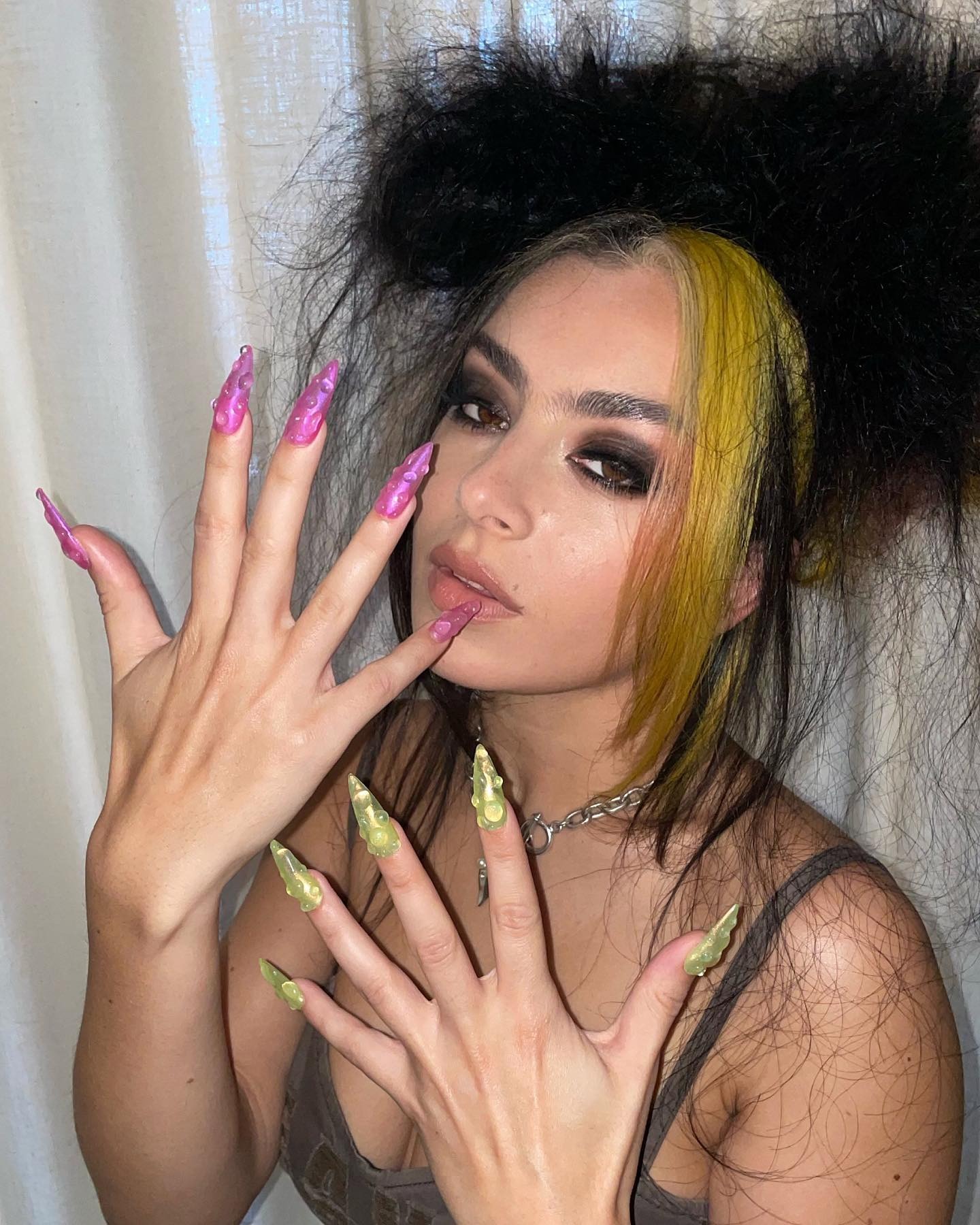 Image posted to Juan Alvear's Instagram of Charli XCX wearing jelly nails.