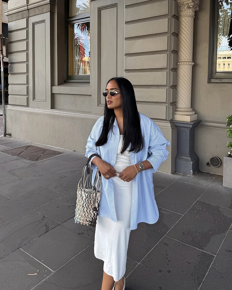 @divrav wears a blue shirt with a white vest top and skirt