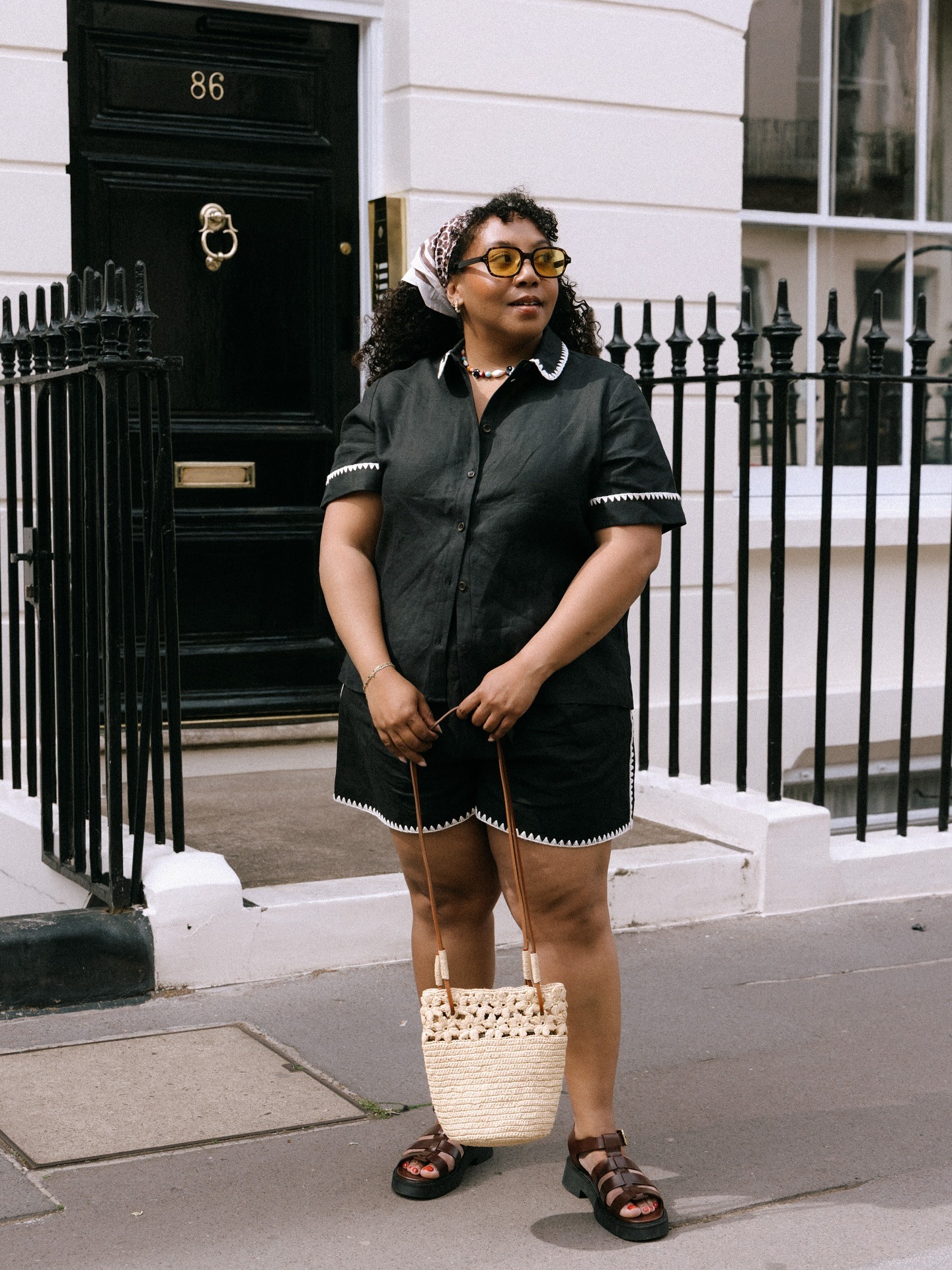 Nicole Ocran wears an all-black summer outfit.