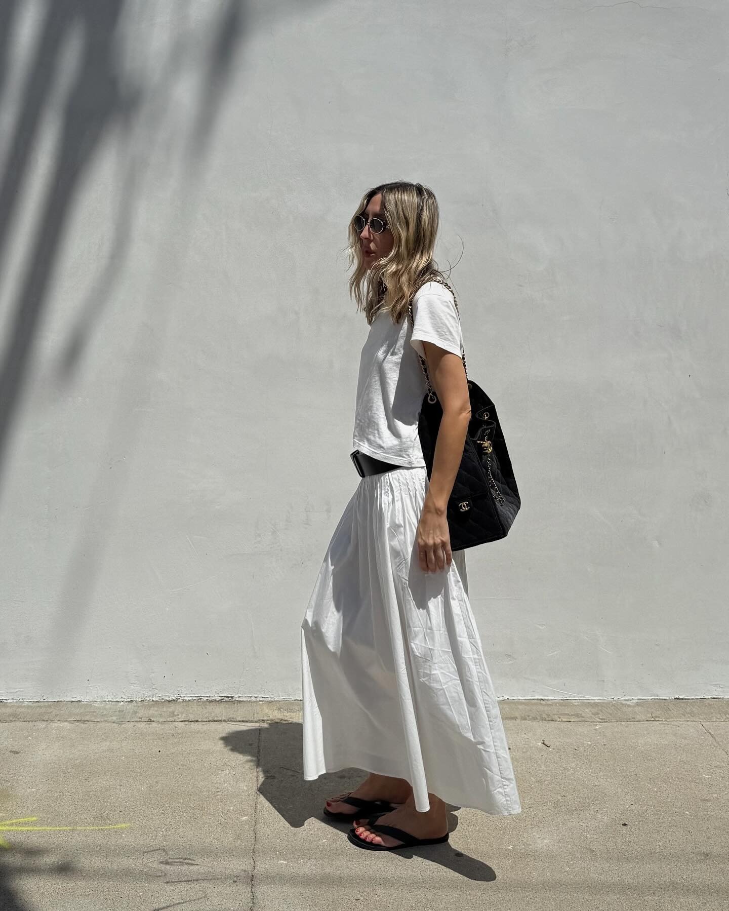 Influencer wearing a white T-shirt and long skirt