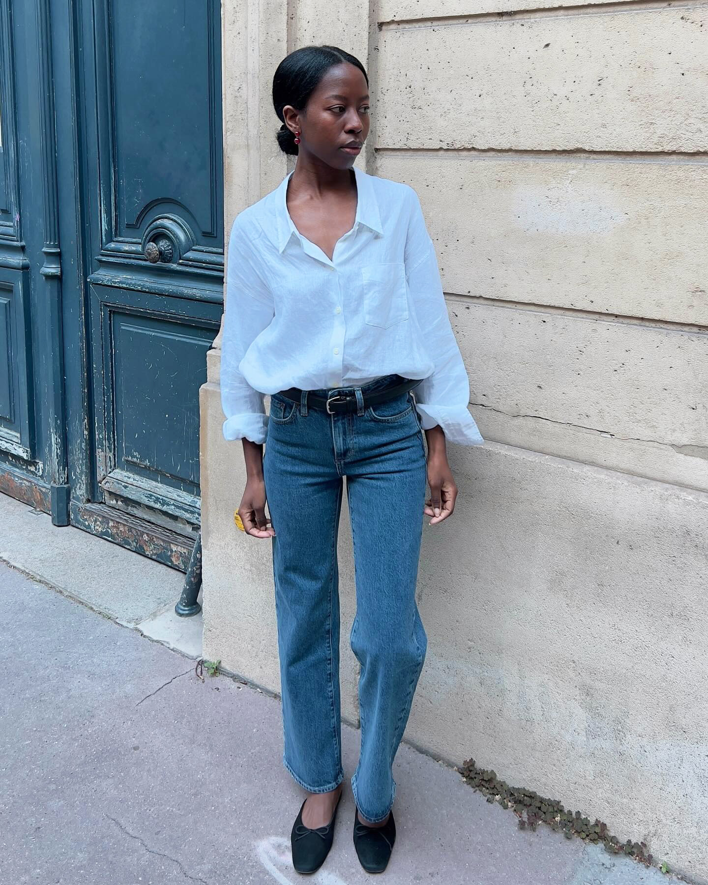 Influencer wearing a white button-down shirt with jeans