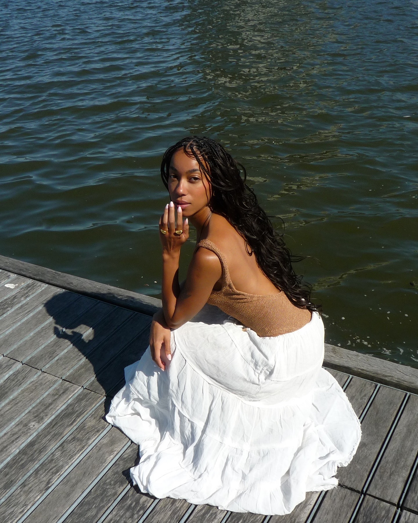 Influencer wearing a swimsuit and long white skirt