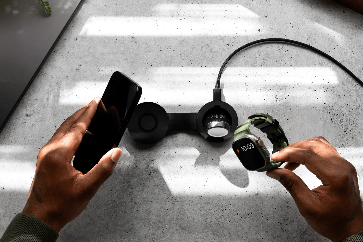 The Twelve South ButterFly SE 2-in-1 Qi2 Charger set up on a table with an iPhone and Apple Watch Ultra.